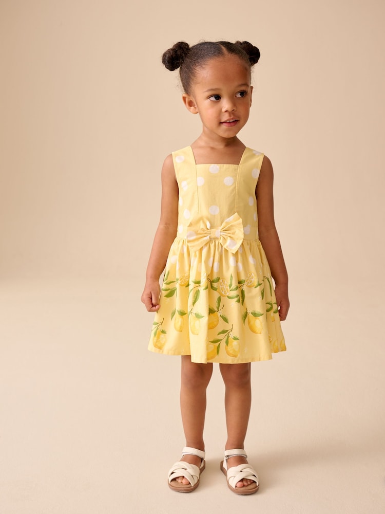 Yellow Lemon Spot Bow Front Prom Dress (3mths-8yrs) - Image 1 of 4 Yellow Lemon Spot Bow Front Prom Dress (3mths-8yrs) - Image 1 of 4