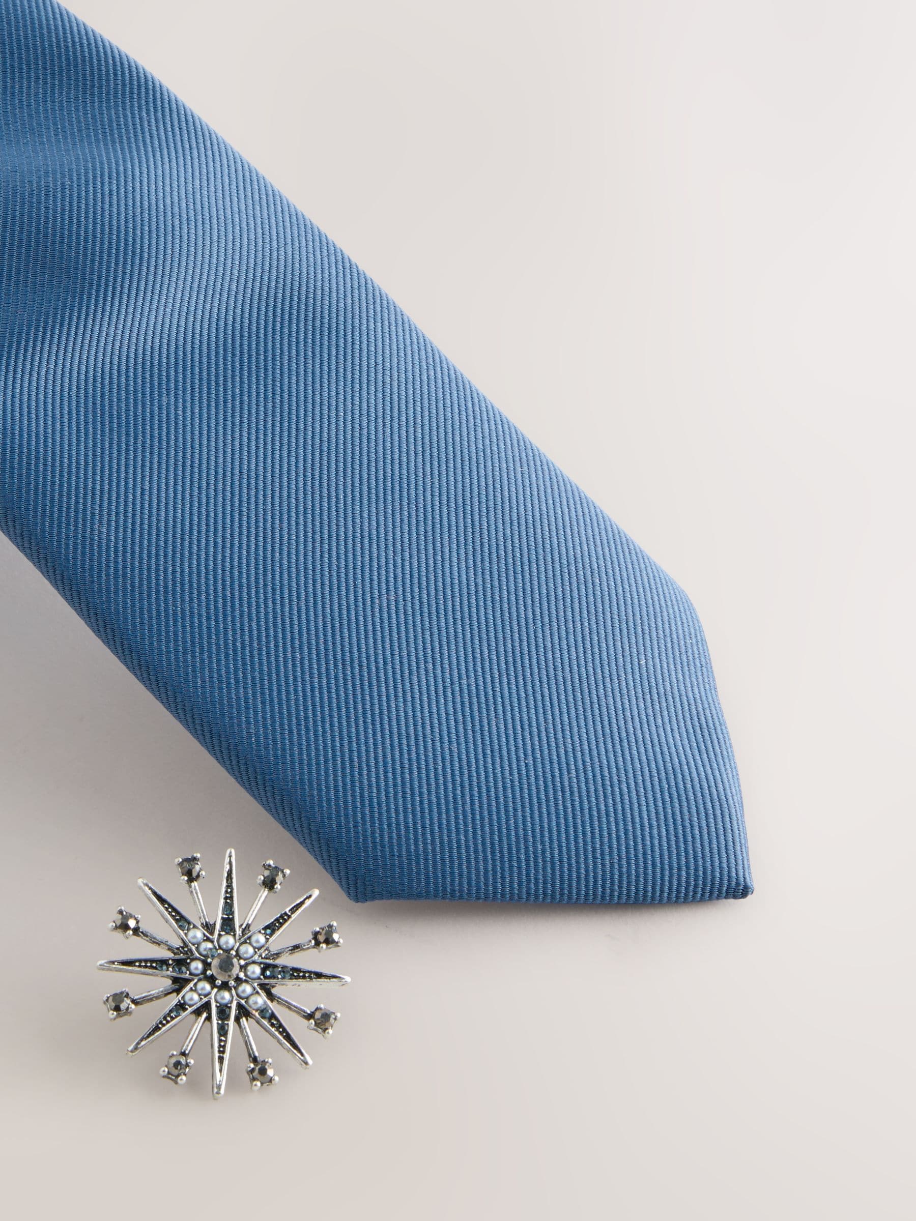 brooch on tie