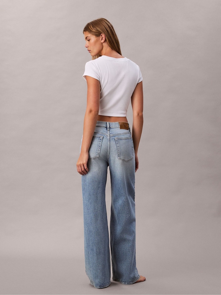 Calvin Klein Blue Allover Monogram Low Rise Baggy Jeans - Image 1 of 5 Calvin Klein Blue Allover Monogram Low Rise Baggy Jeans - Image 1 of 5