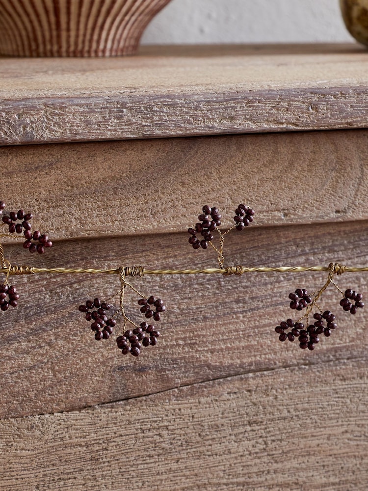 Nkuku Brass and Ruby Tanu Mango Wood Beaded Christmas Garland - Image 2 of 3