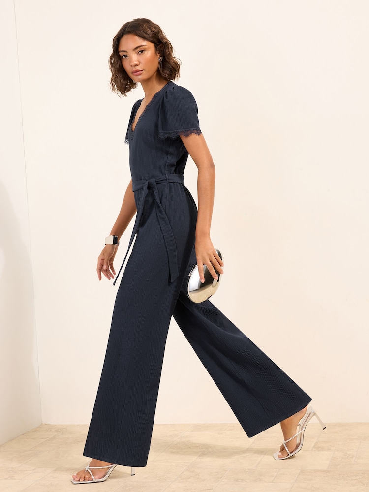 Friends Like These Navy Petite Lace Trim Detail Short Sleeve Jumpsuit - Image 1 of 5