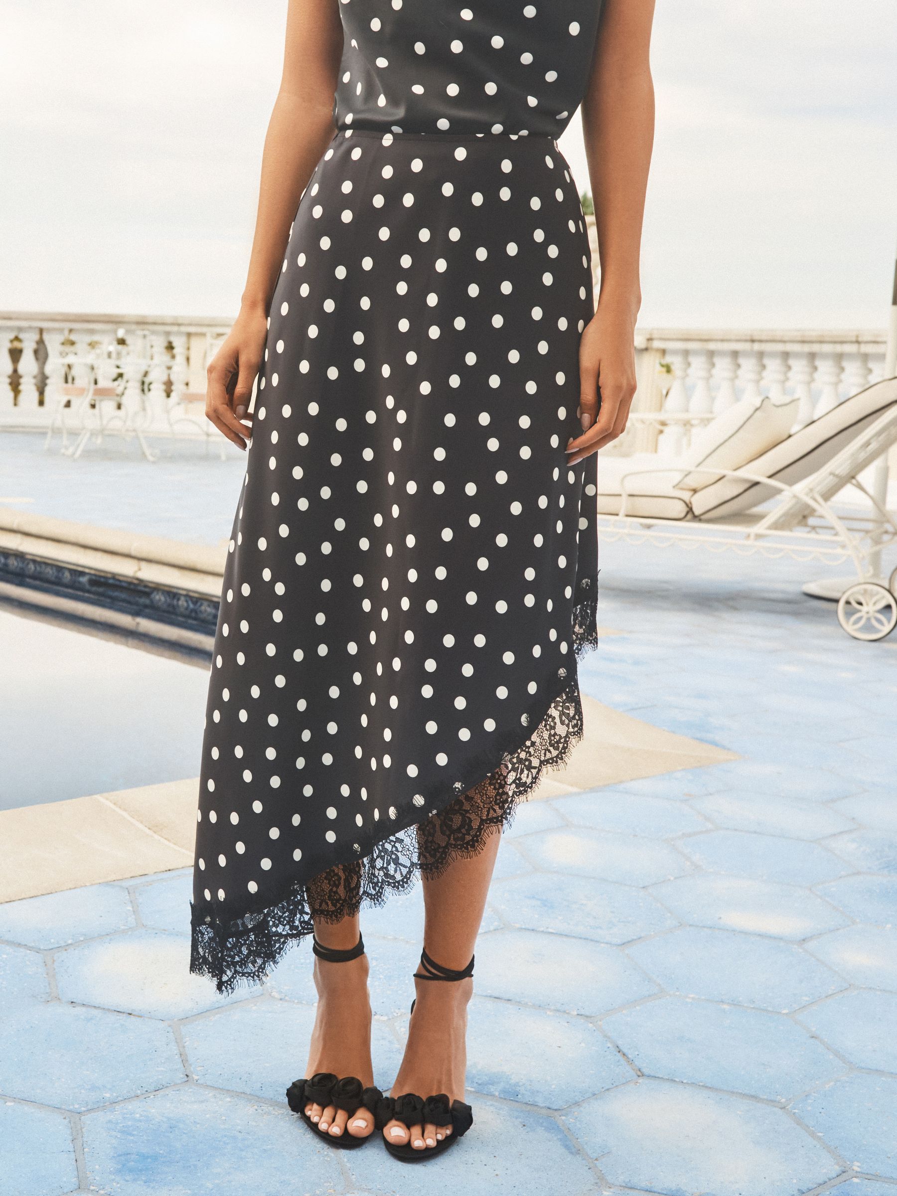 Buy Lipsy Black Polka Dot Lace Satin Asymmetric Midi Skirt from