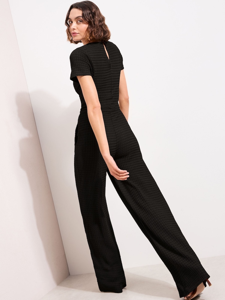 Friends Like These Black Petite Short Sleeve Jersey Textured Jumpsuit - Image 4 of 4 Friends Like These Black Petite Short Sleeve Jersey Textured Jumpsuit - Image 4 of 4
