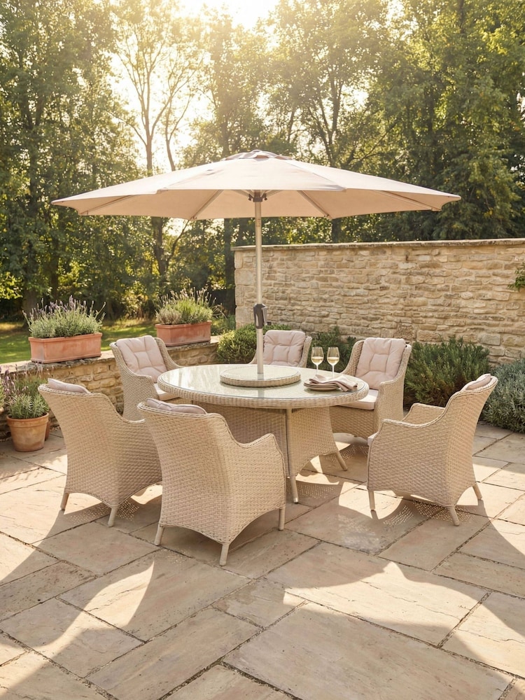 Bramblecrest Sandstone Woodchester Elliptical Table with 6 Dining Armchairs and Parasol - Image 1 of 6 Bramblecrest Sandstone Woodchester Elliptical Table with 6 Dining Armchairs and Parasol - Image 1 of 6