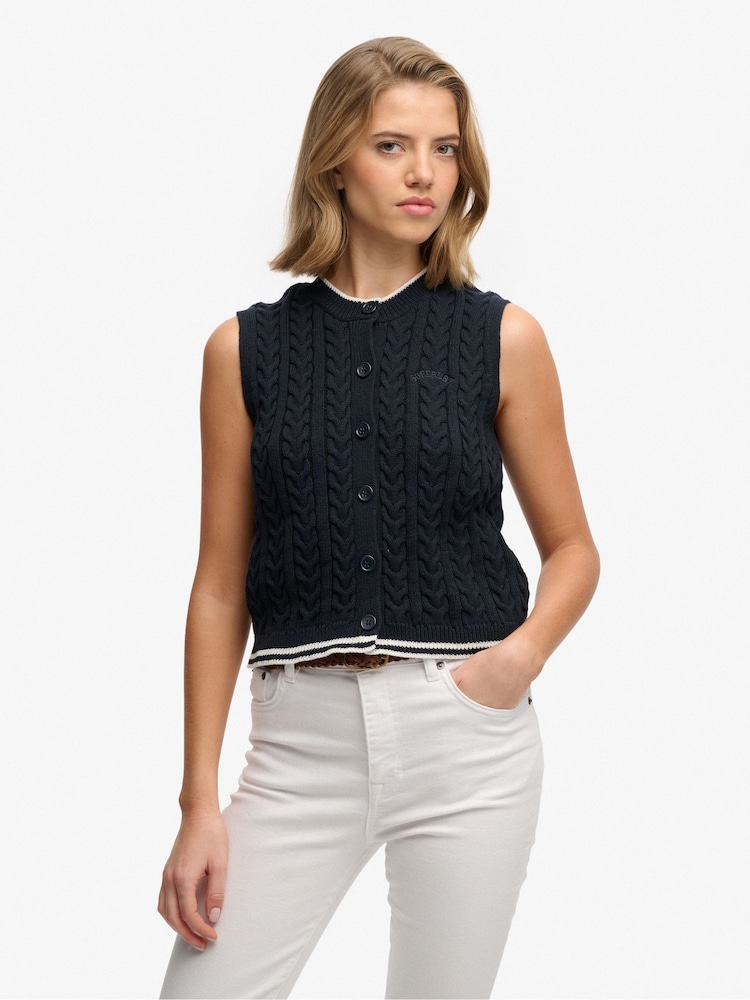 بلوزة بدون أكمام محبوكة بنمط كابل بأزرار أمامية من Superdry - Image 1 of 4 بلوزة بدون أكمام محبوكة بنمط كابل بأزرار أمامية من Superdry - Image 1 of 4