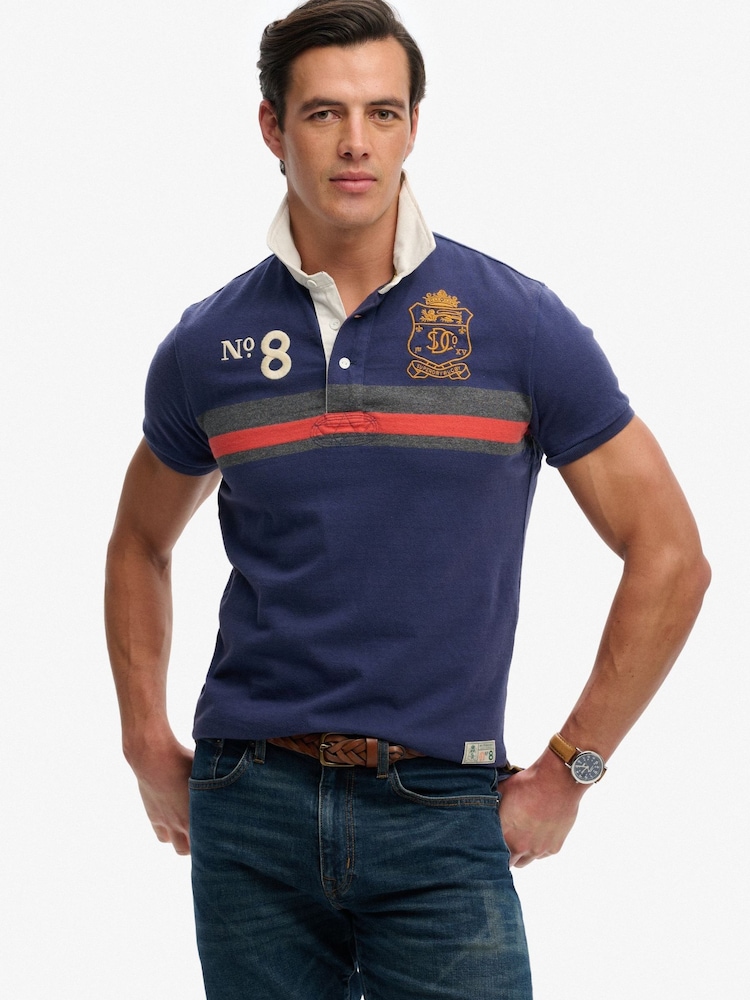Superdry Blue Double Emblem Jersey Short Sleeve Rugby Polo Top - Image 1 of 5 Superdry Blue Double Emblem Jersey Short Sleeve Rugby Polo Top - Image 1 of 5
