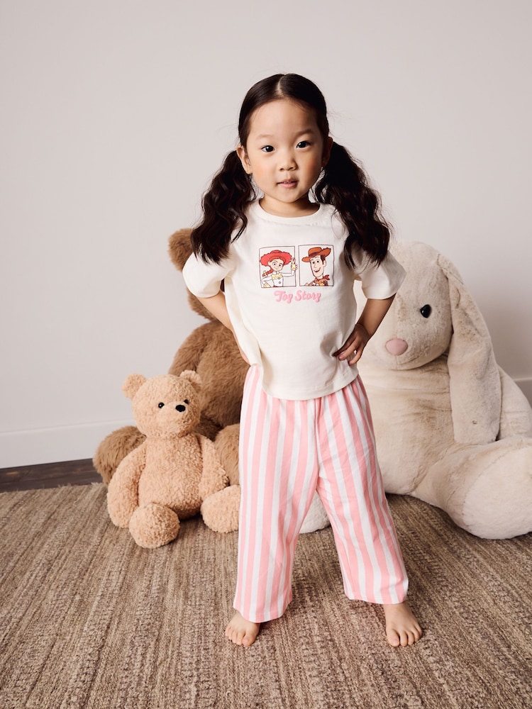 Ecru/Pink Toy Story Wide Leg Pyjamas 1 Pack (9mths-10yrs) - Image 1 of 8 Ecru/Pink Toy Story Wide Leg Pyjamas 1 Pack (9mths-10yrs) - Image 1 of 8