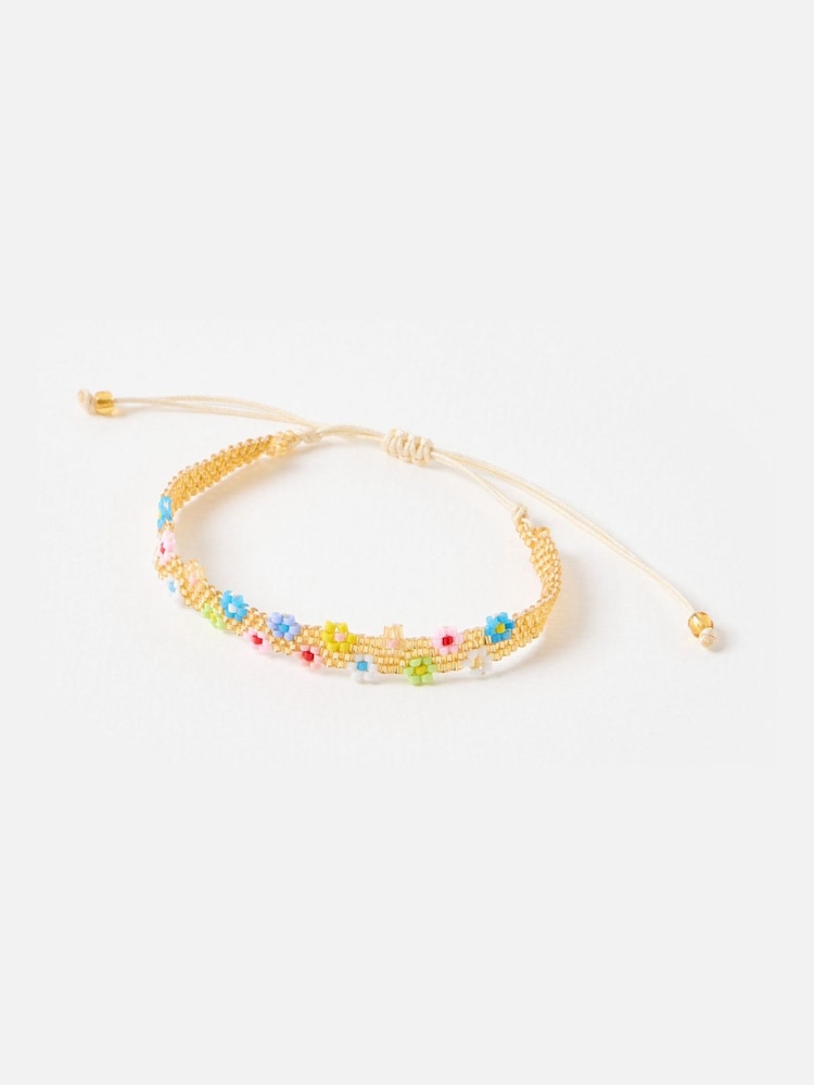 Oliver Bonas Gold Tone Nora Beaded Flower Friendship Bracelet - Image 1 of 4 Oliver Bonas Gold Tone Nora Beaded Flower Friendship Bracelet - Image 1 of 4