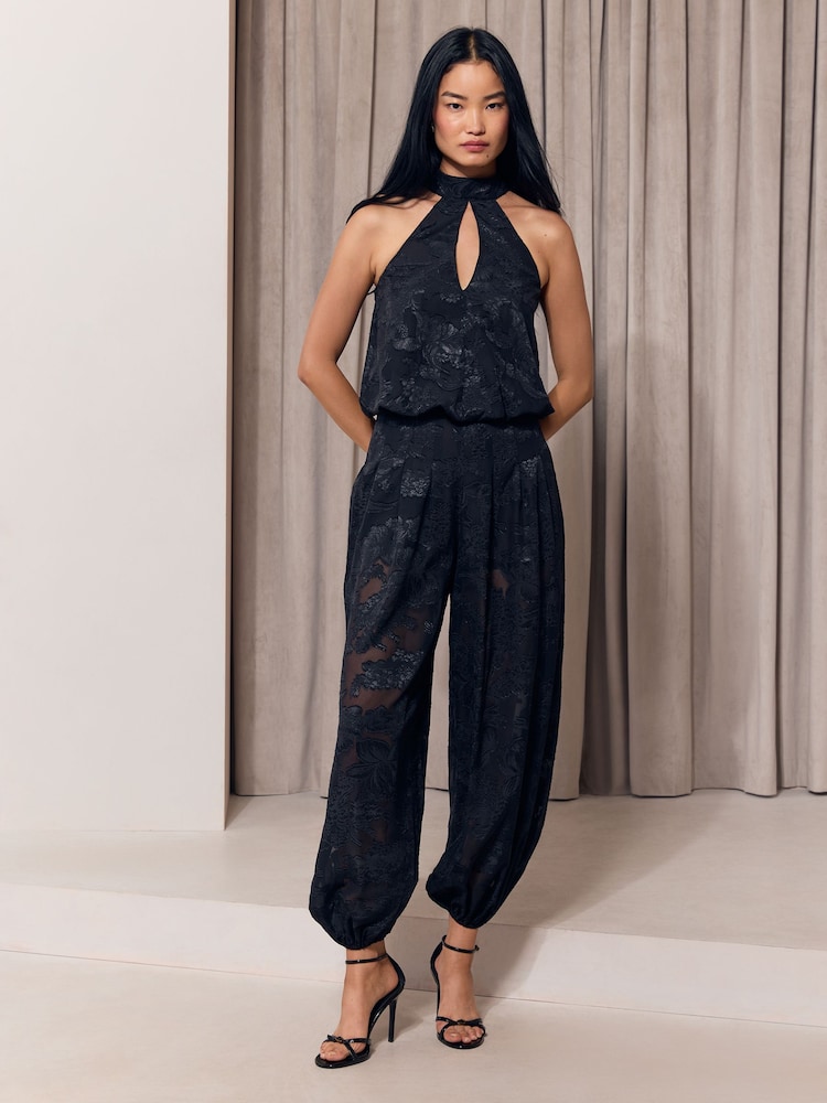 Lipsy Black Halter Neck Burnout Sheer Balloon Pant Jumpsuit - Image 1 of 5