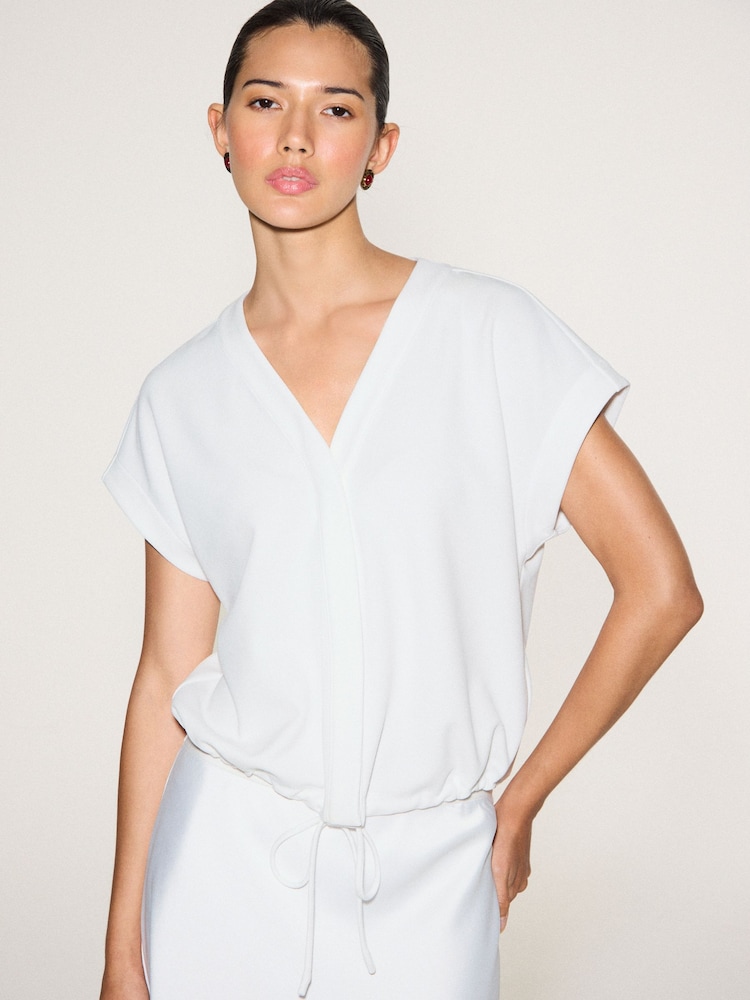 Ecru Short Sleeve V-Neck Bubblehem Top - Image 1 of 10 Ecru Short Sleeve V-Neck Bubblehem Top - Image 1 of 10