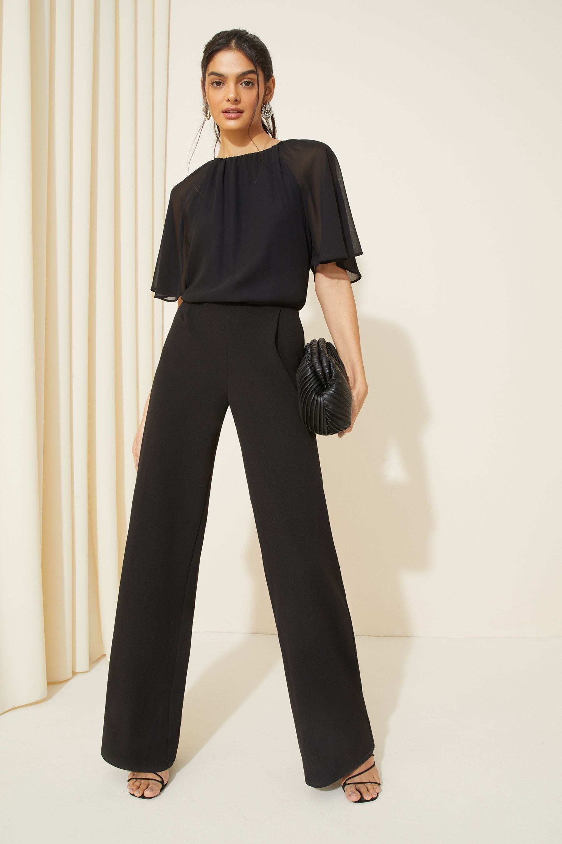 Buy Friends Like These Black Chiffon Flutter Sleeve Wide Leg Jumpsuit from the Next UK online shop