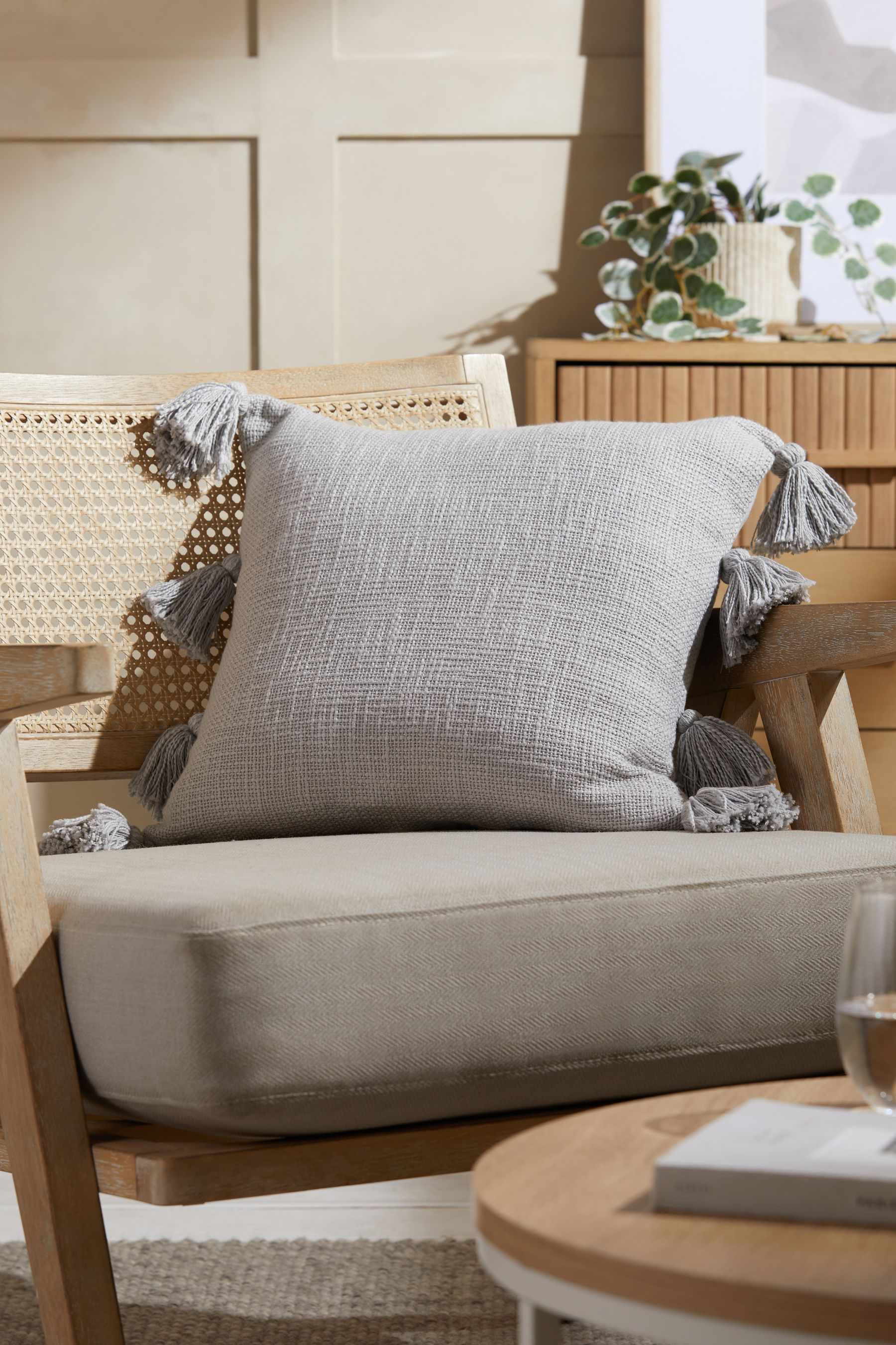 Grey tassel deals cushion