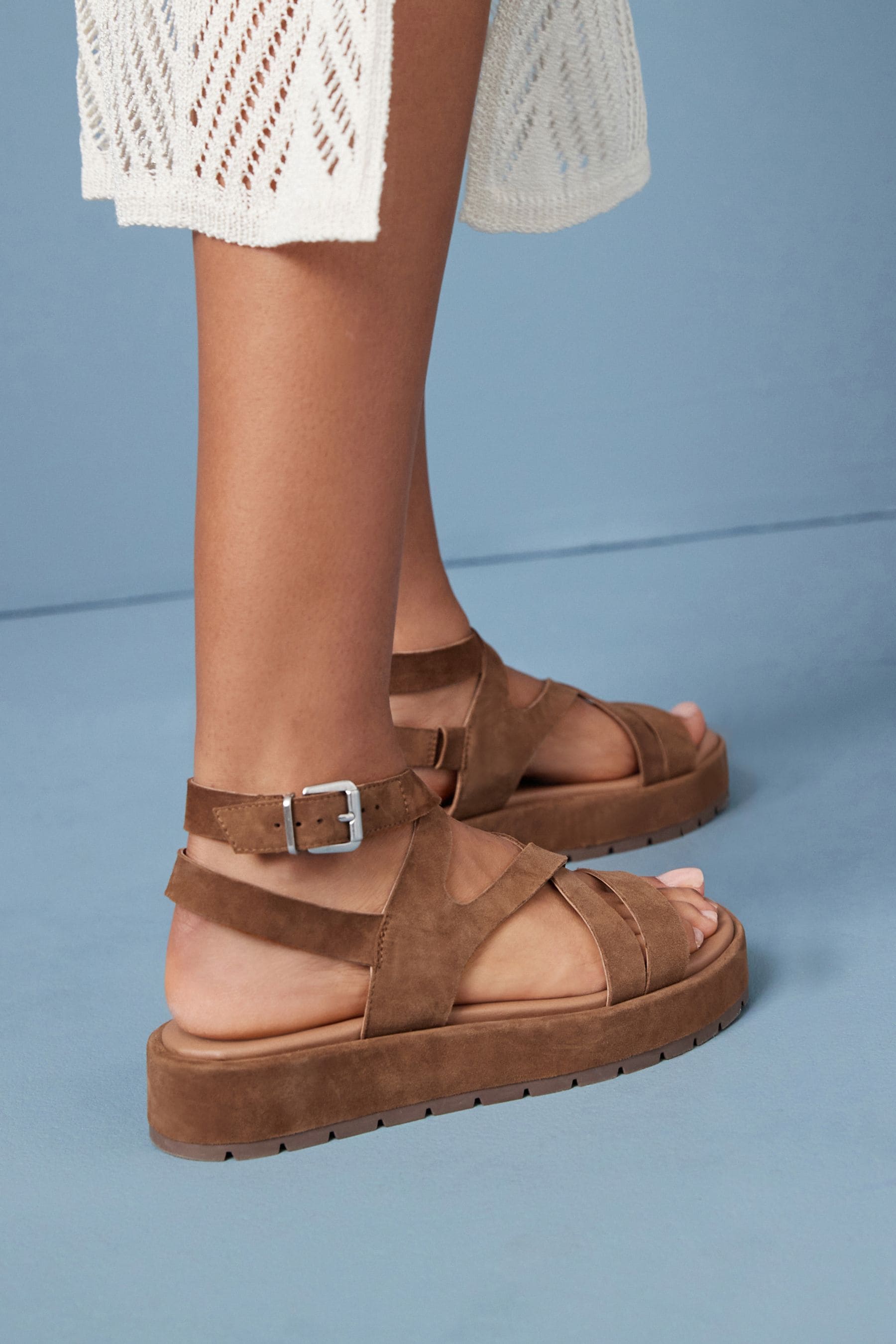 Tan leather flatforms store