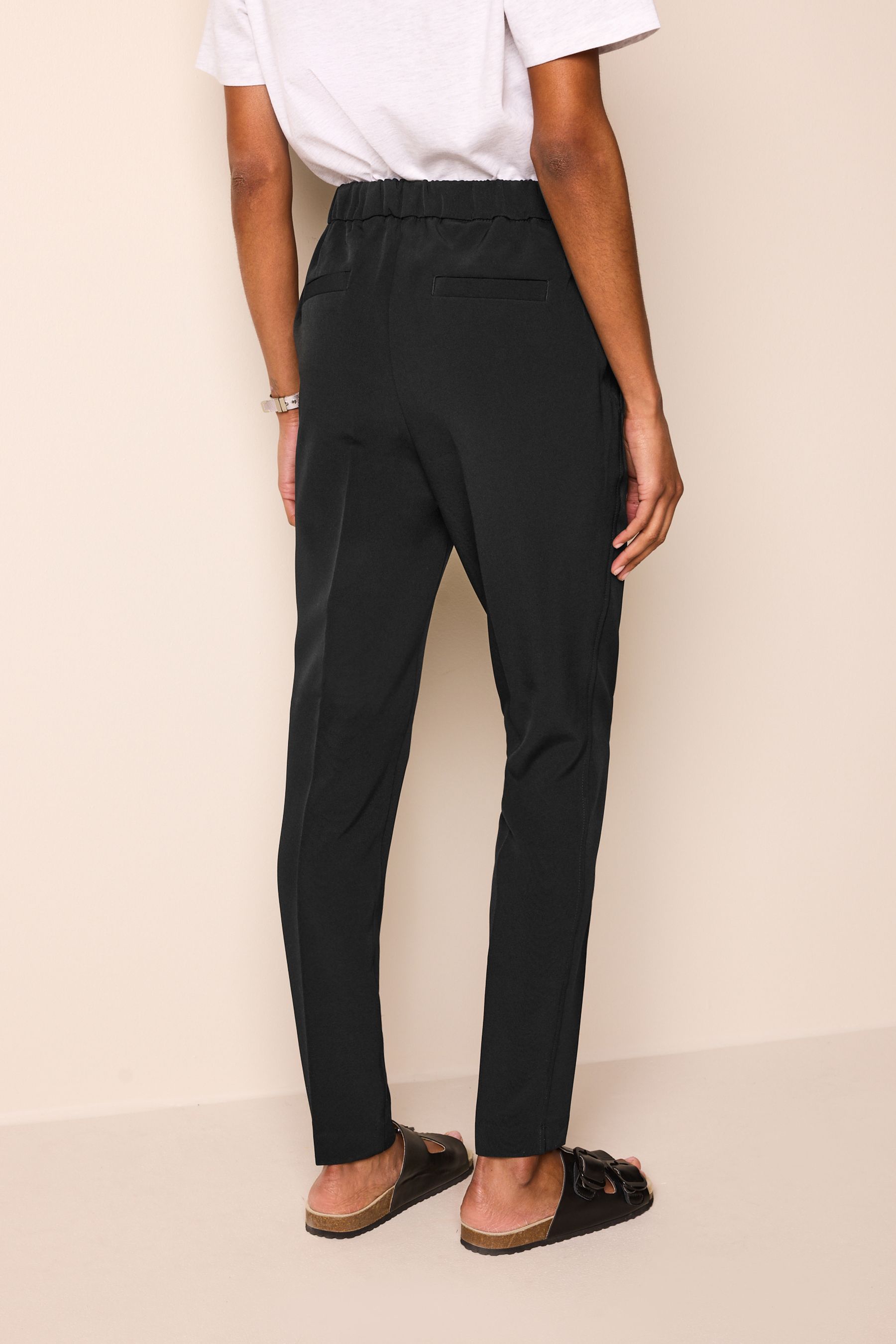 Buy Black Tailored Elastic Back Skinny Leg Trousers from the Next UK online shop