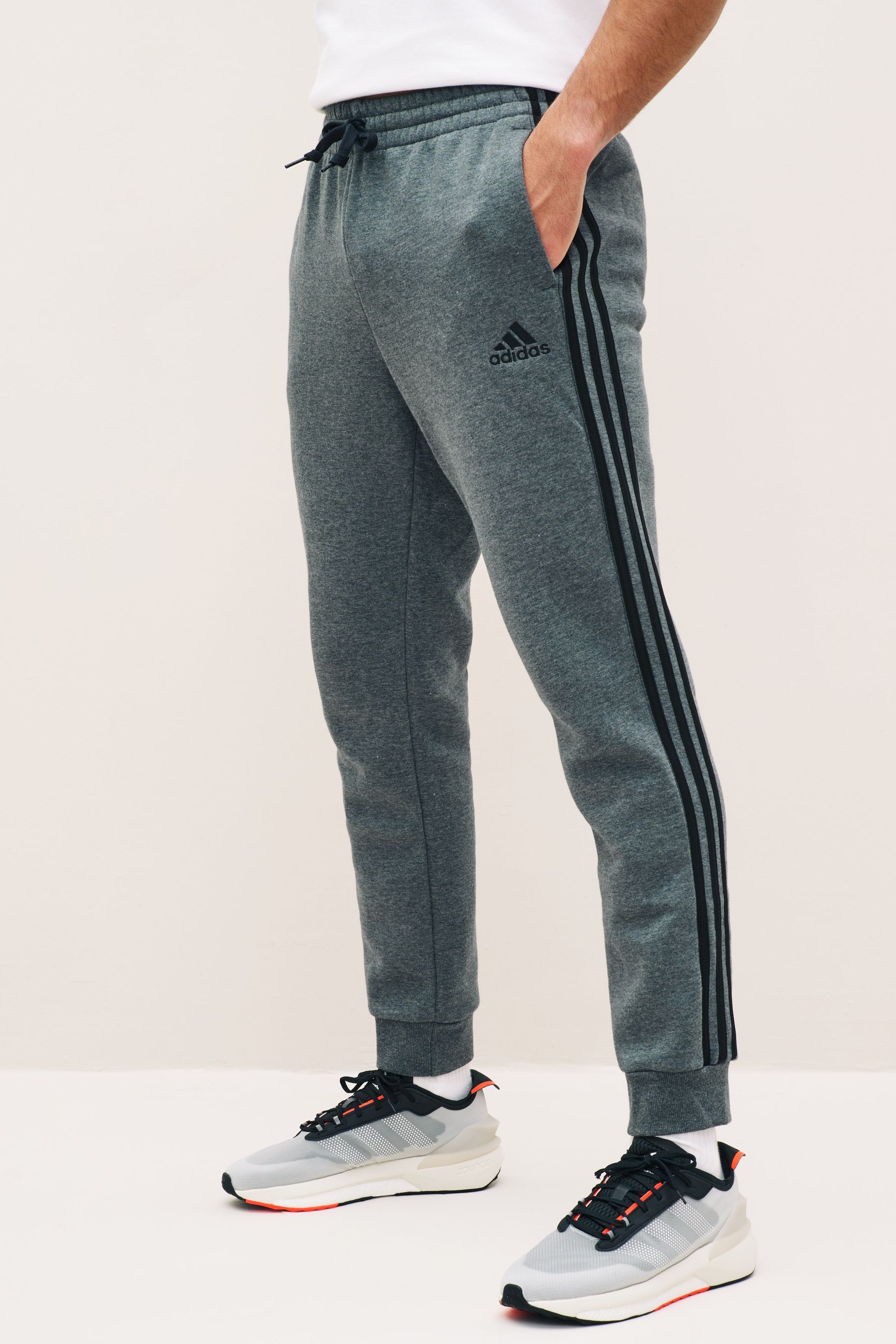 Grey adidas sweatpants with black stripes hot sale