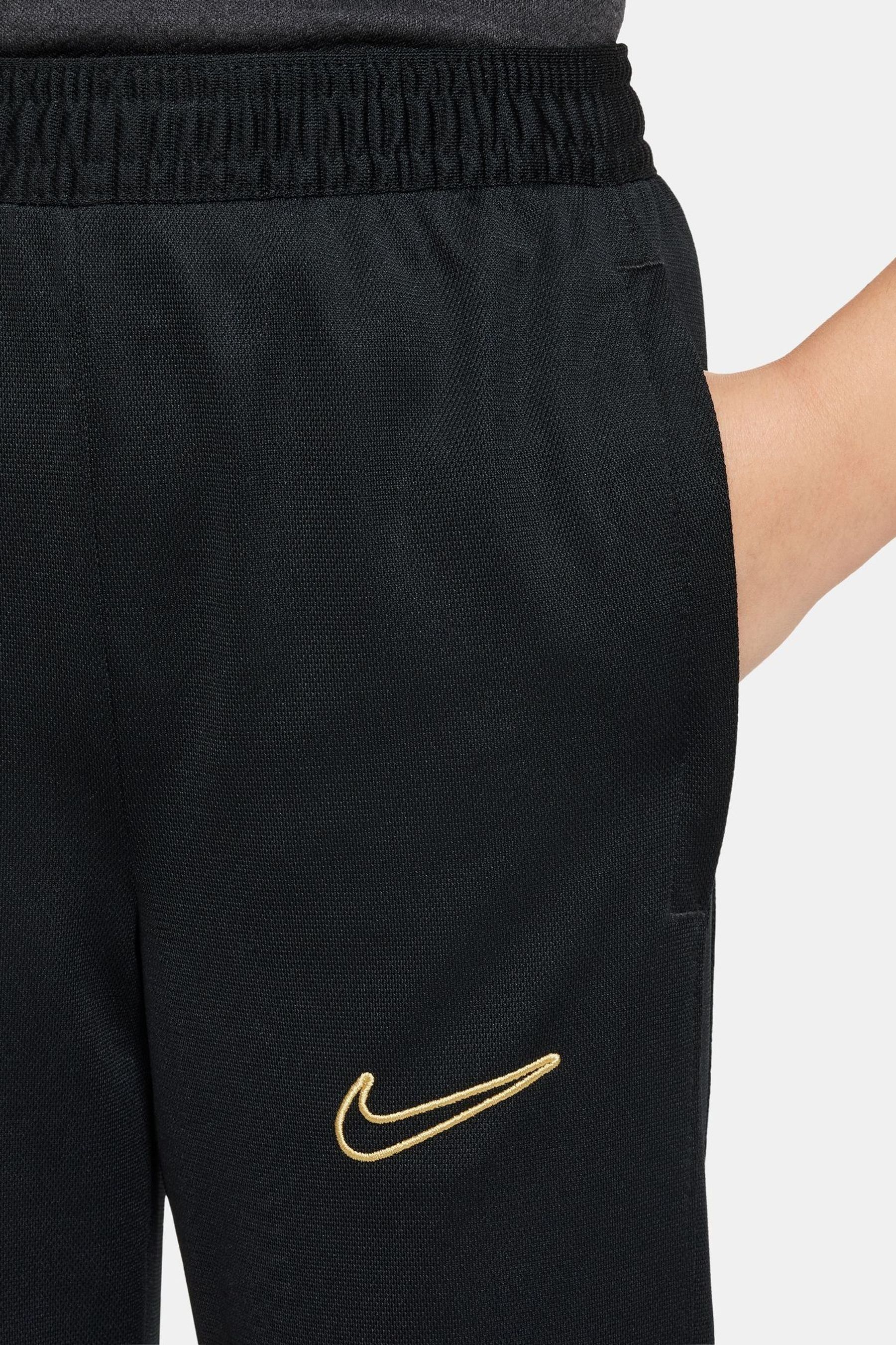 Nike black and gold tracksuit hotsell