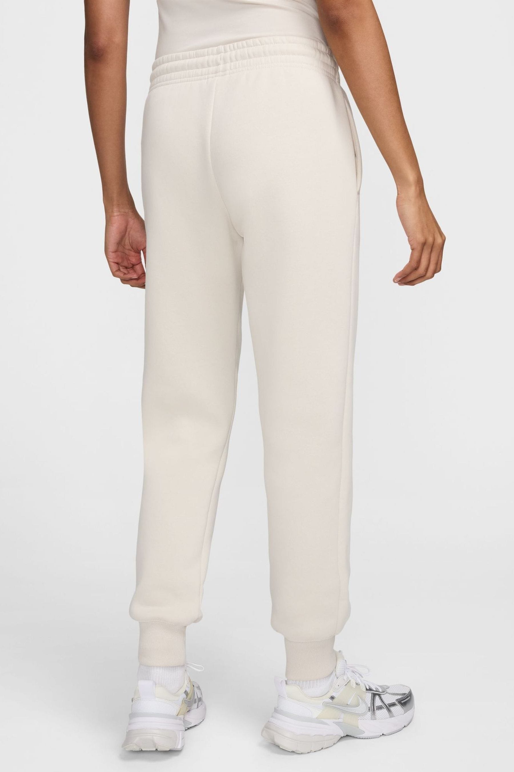 Buy Nike Cream Phoenix Fleece Mid Rise Logo Joggers from the Next UK online shop