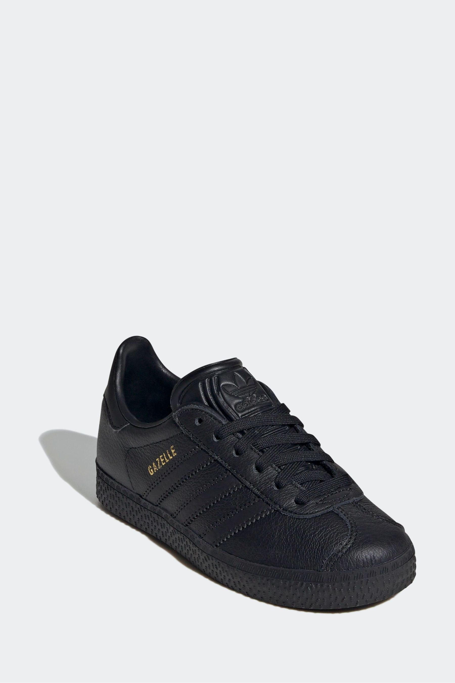 Black leather adidas gazelle junior hotsell