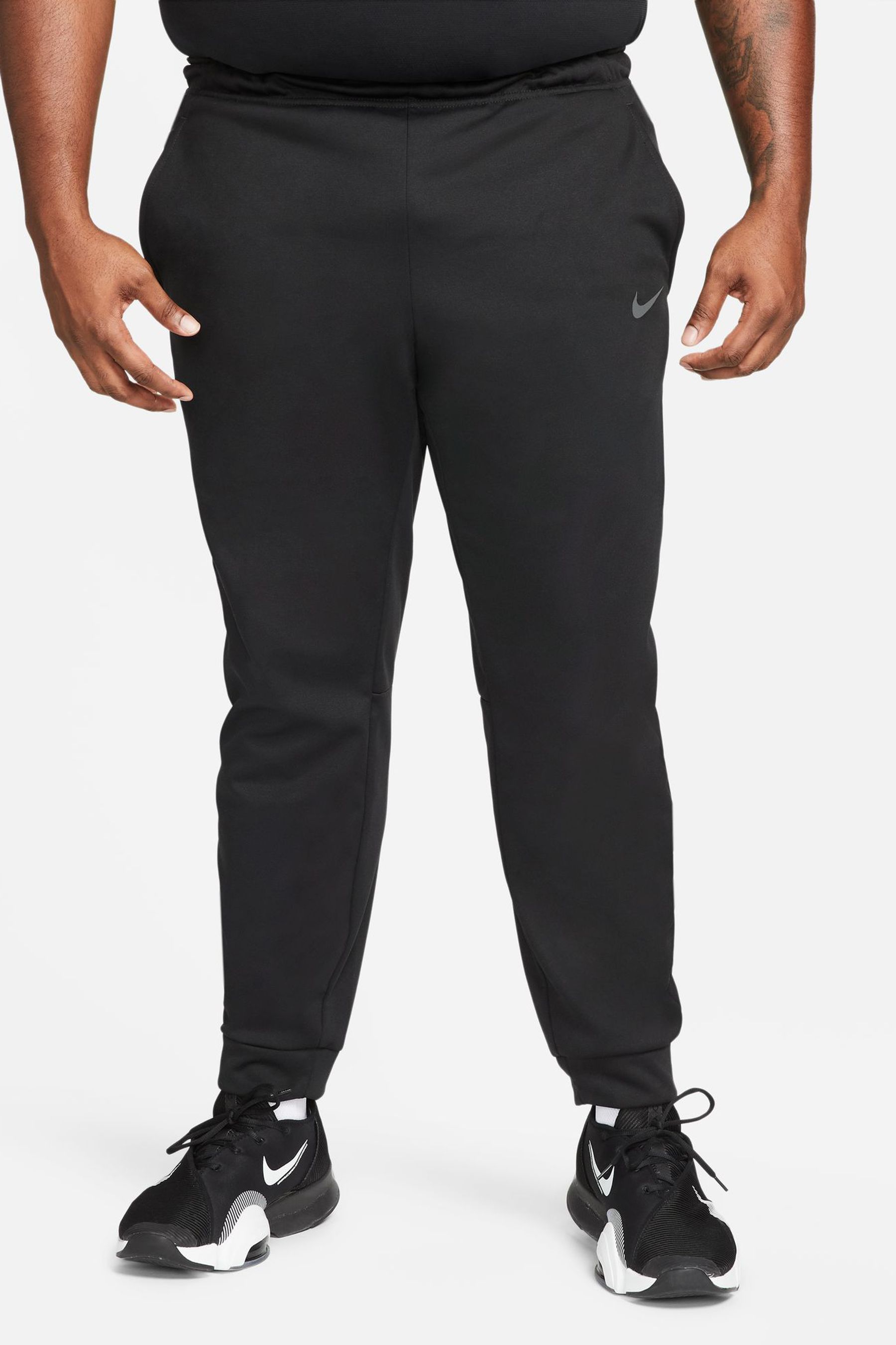 Nike training therma tapered joggers in black hotsell