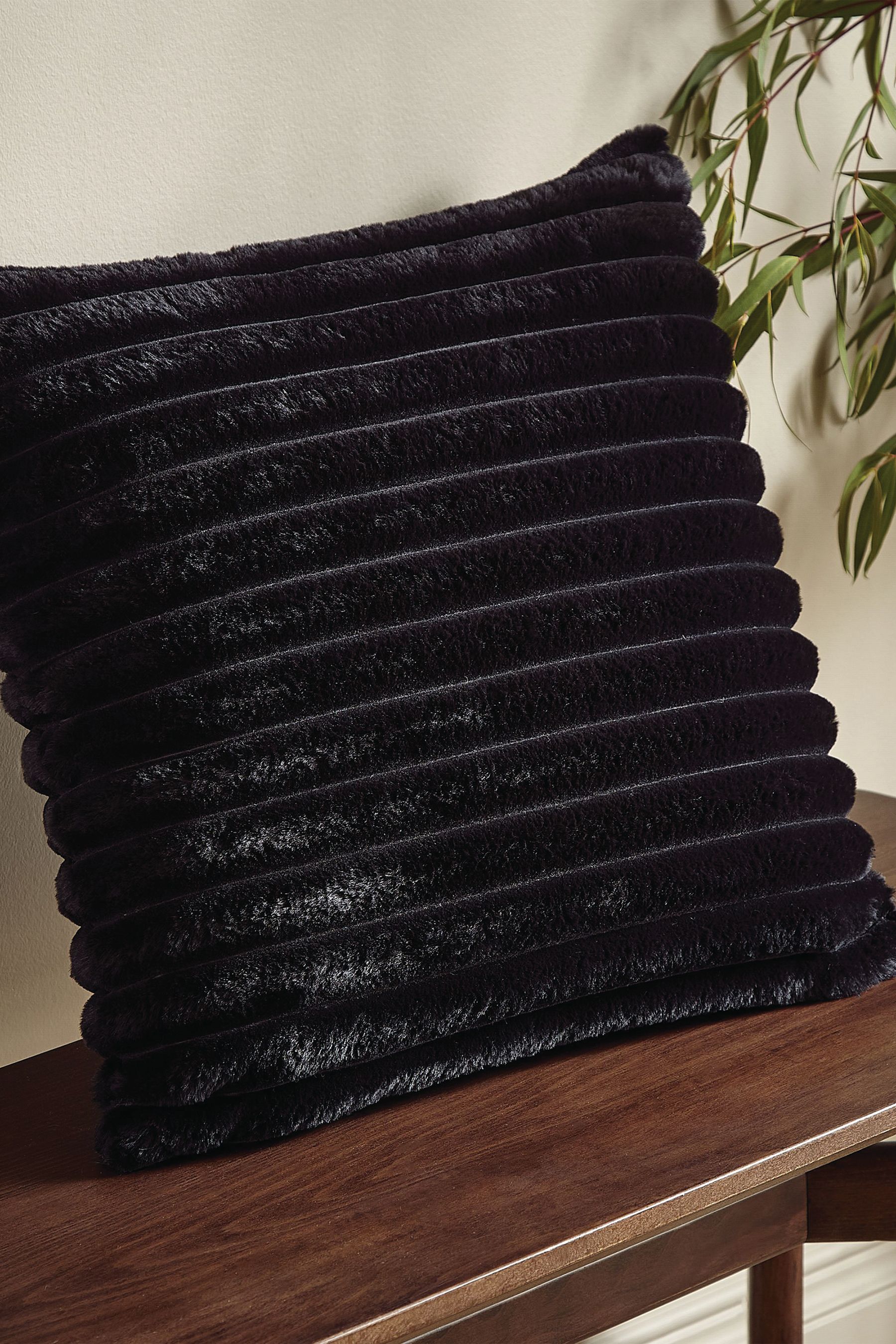 Black fuzzy throw pillow top