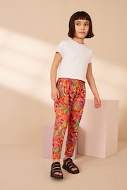 Rust Orange/ Pink Tropical Flower Print Jersey Stretch Lightweight Trousers (3-16yrs) - Image 3 of 8