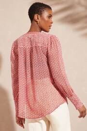 Love & Roses Ivory White and Red Geo Chiffon V Neck Long Sleeve Over The Head Blouse - Image 4 of 4