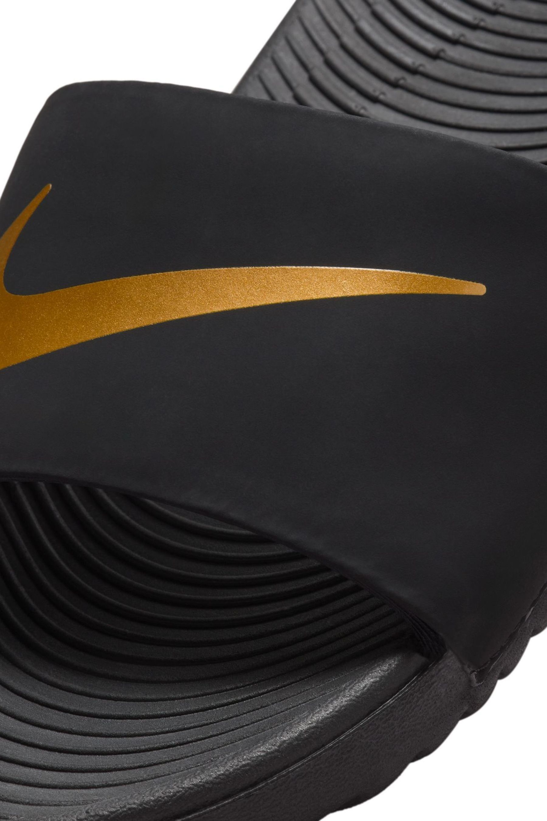 Black gold nike slides top