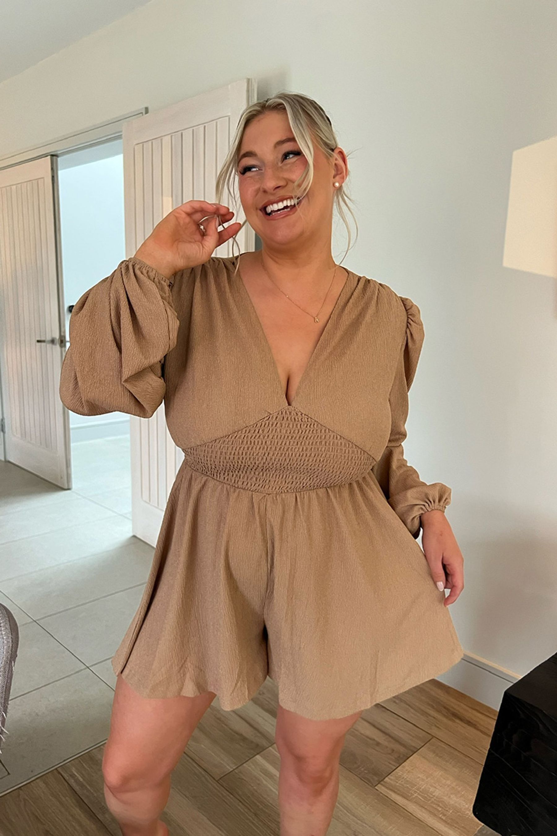 Buy In The Style Beige Carys Whittaker Shirred Waist Button Detail Plunge Long Sleeve Playsuit from Next Luxembourg