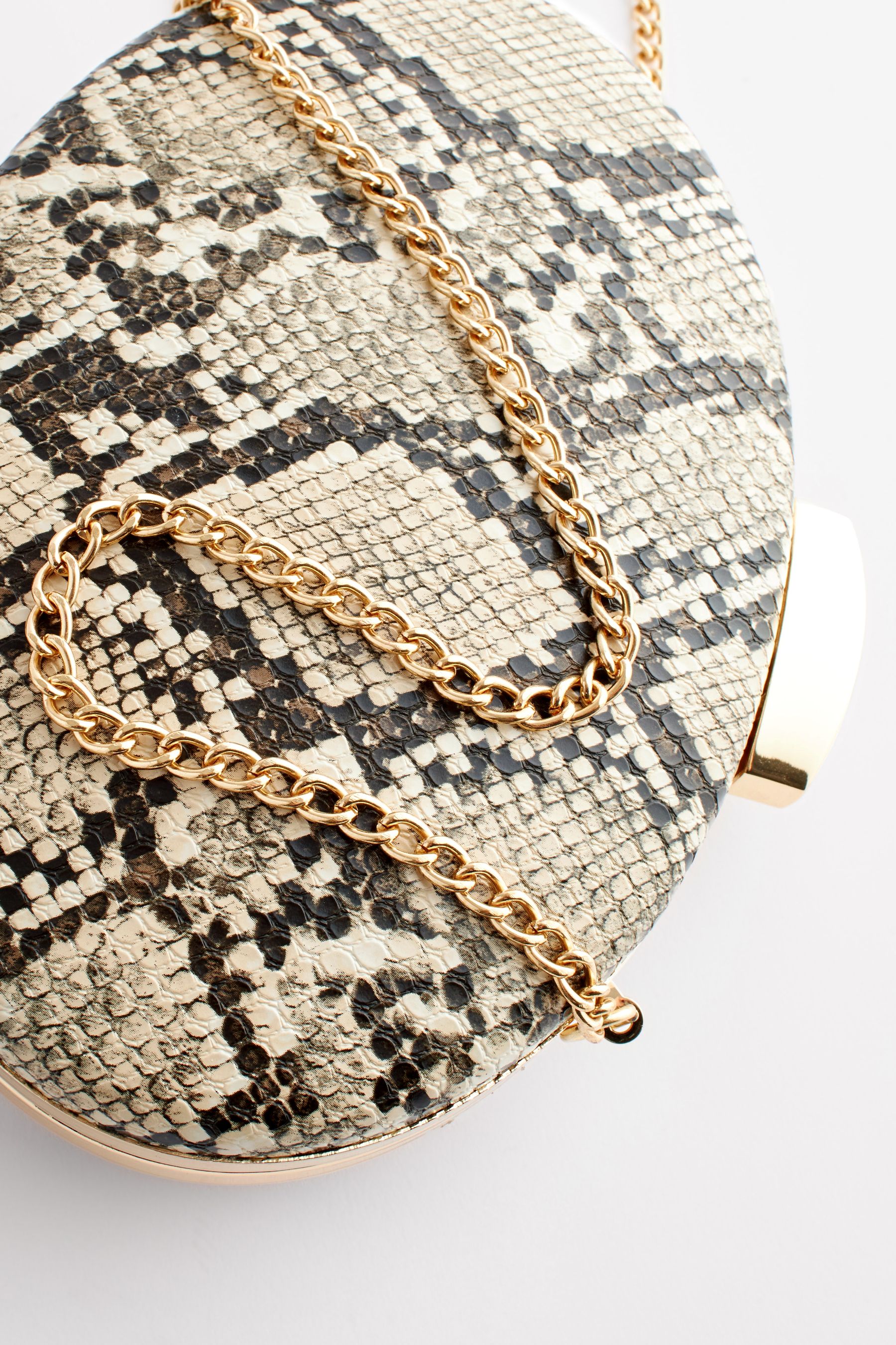 Buy Neutral Snake Print Boxy Oval Snap Clutch Bag from Next Germany