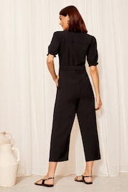 Friends Like These Black Petite Puff Sleeve Zip Front Tie Waist Jumpsuit - Image 4 of 4