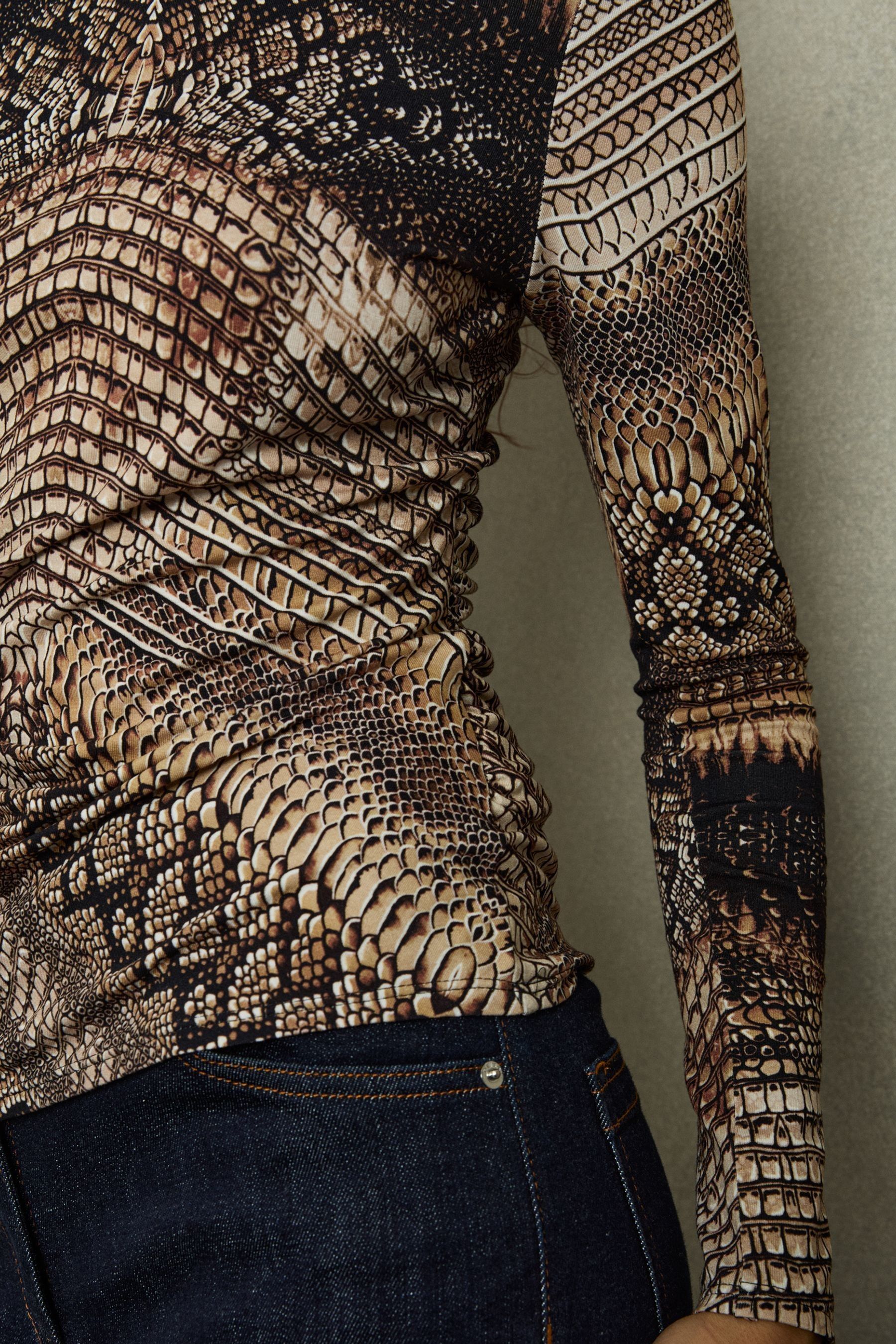 Buy Reiss Brown Naomi Snake Print Roll Neck Top from the Next UK online shop