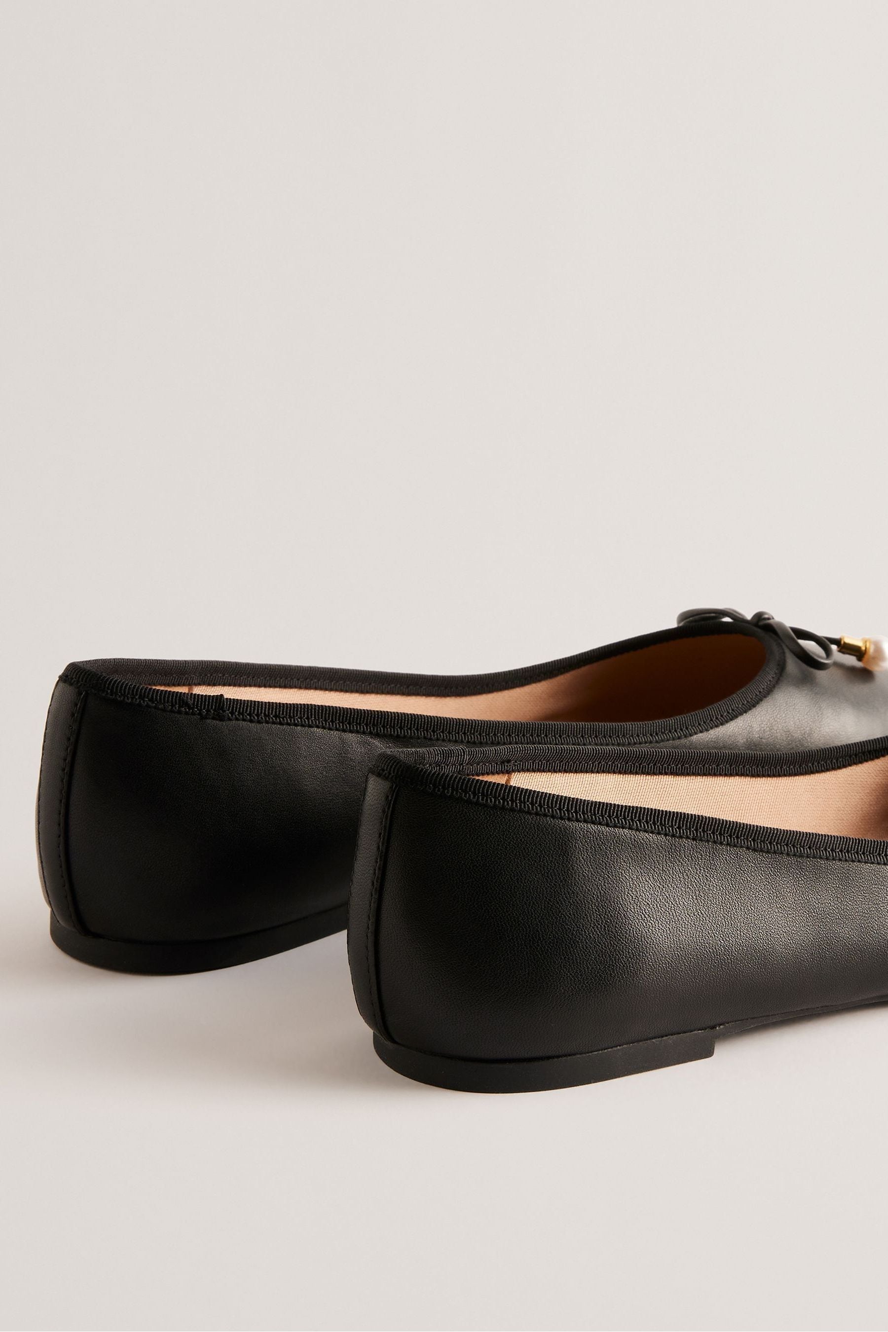 Buy Ted Baker Black Flat Ayvvah Bow Ballerina Shoes With Signature Coin from Next Luxembourg