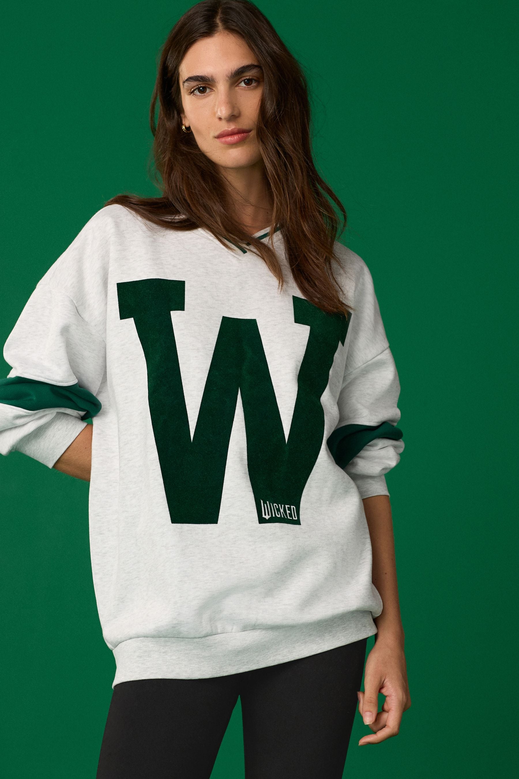 Buy Grey Official Wicked Movie License Varsity Graphic Vee Neck Sweatshirt from Next Ireland