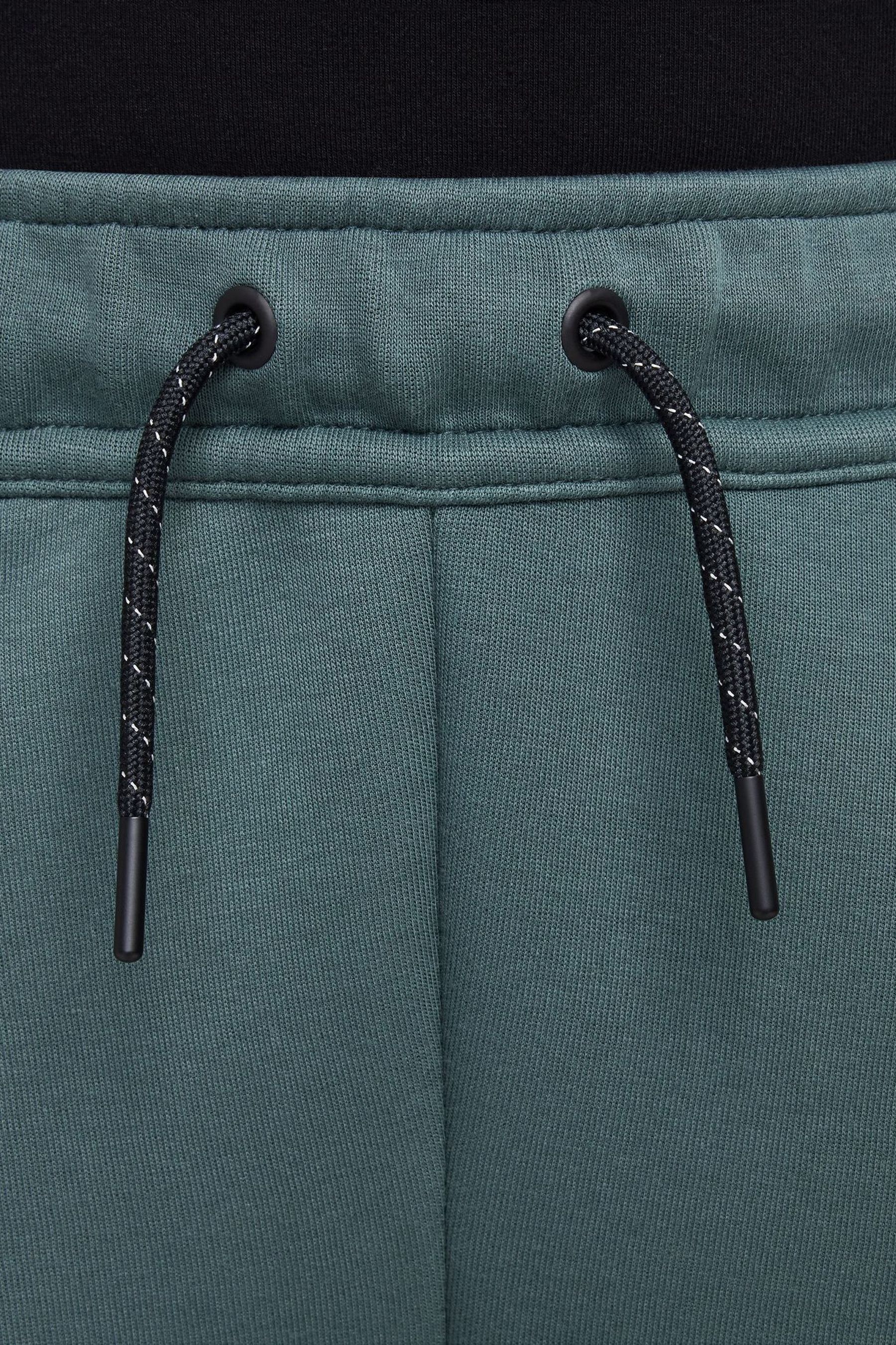 Buy Nike Black Green Tech Fleece Joggers from the Next UK online shop