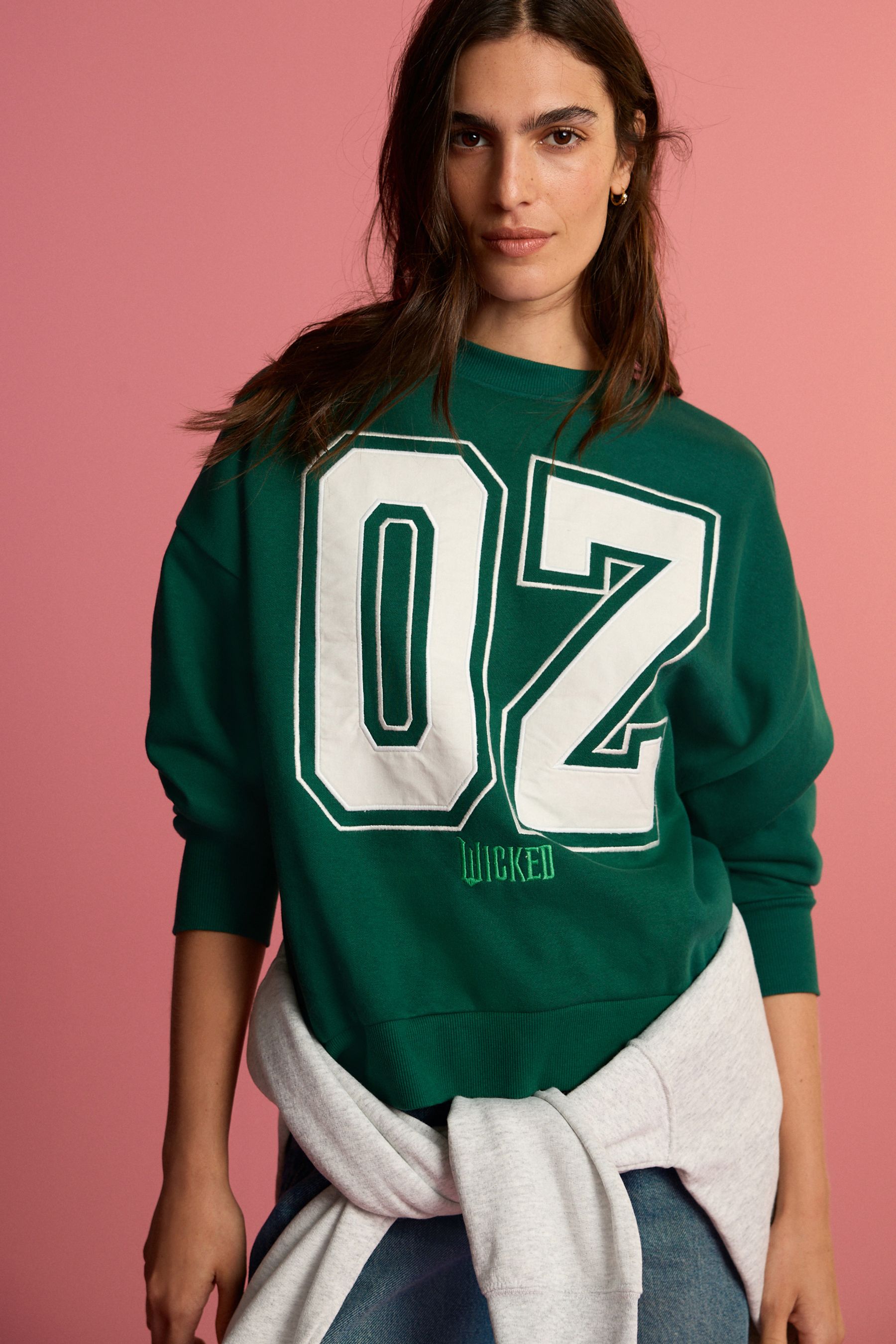 Buy Forest Green Official Wicked Movie License Oz Varsity Green Crewneck Sweatshirt from Next Luxembourg