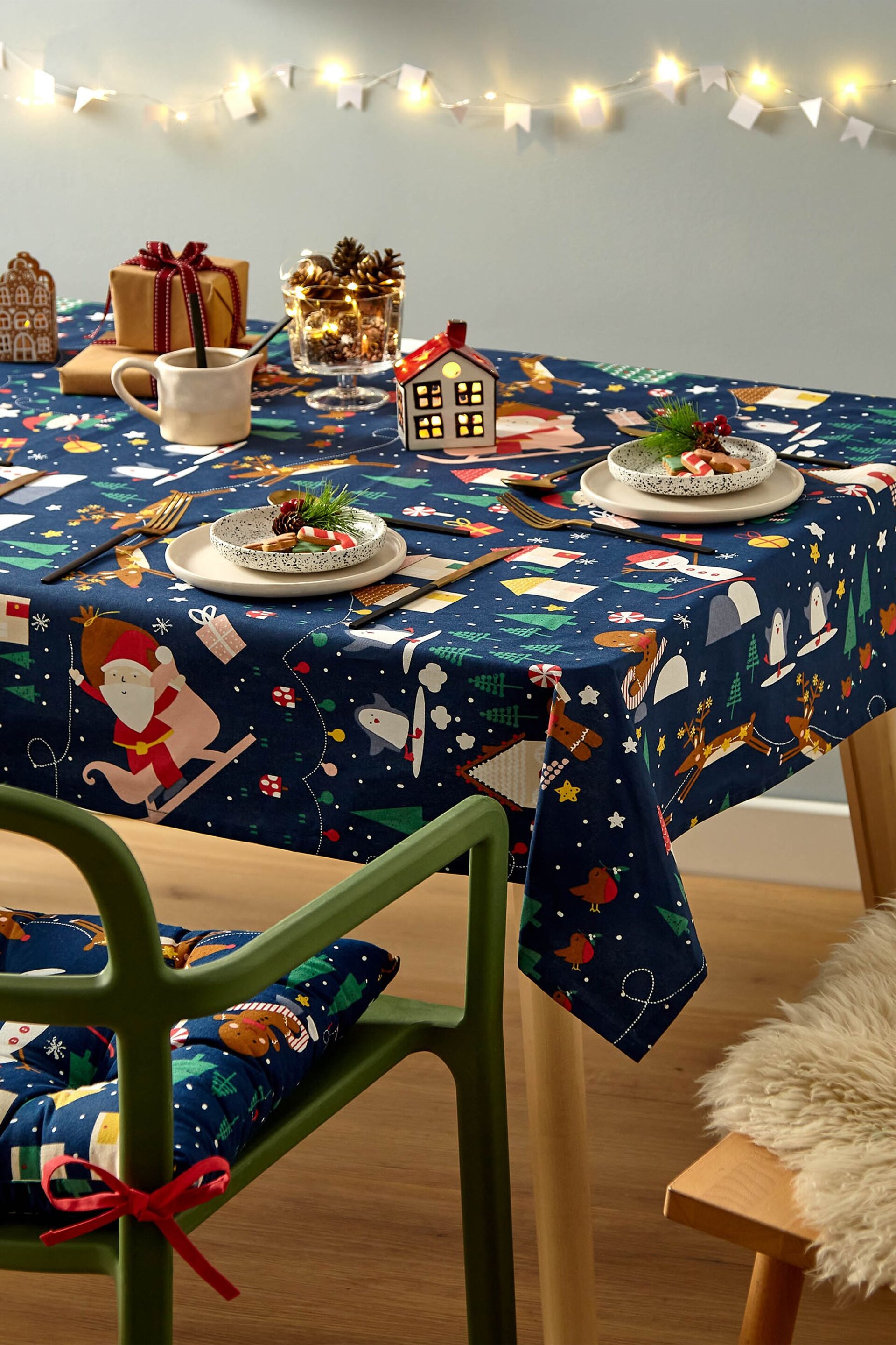 Catherine Lansfield Blue Santa's Christmas Wonderland Wipeable Table Cloth - Image 1 of 3