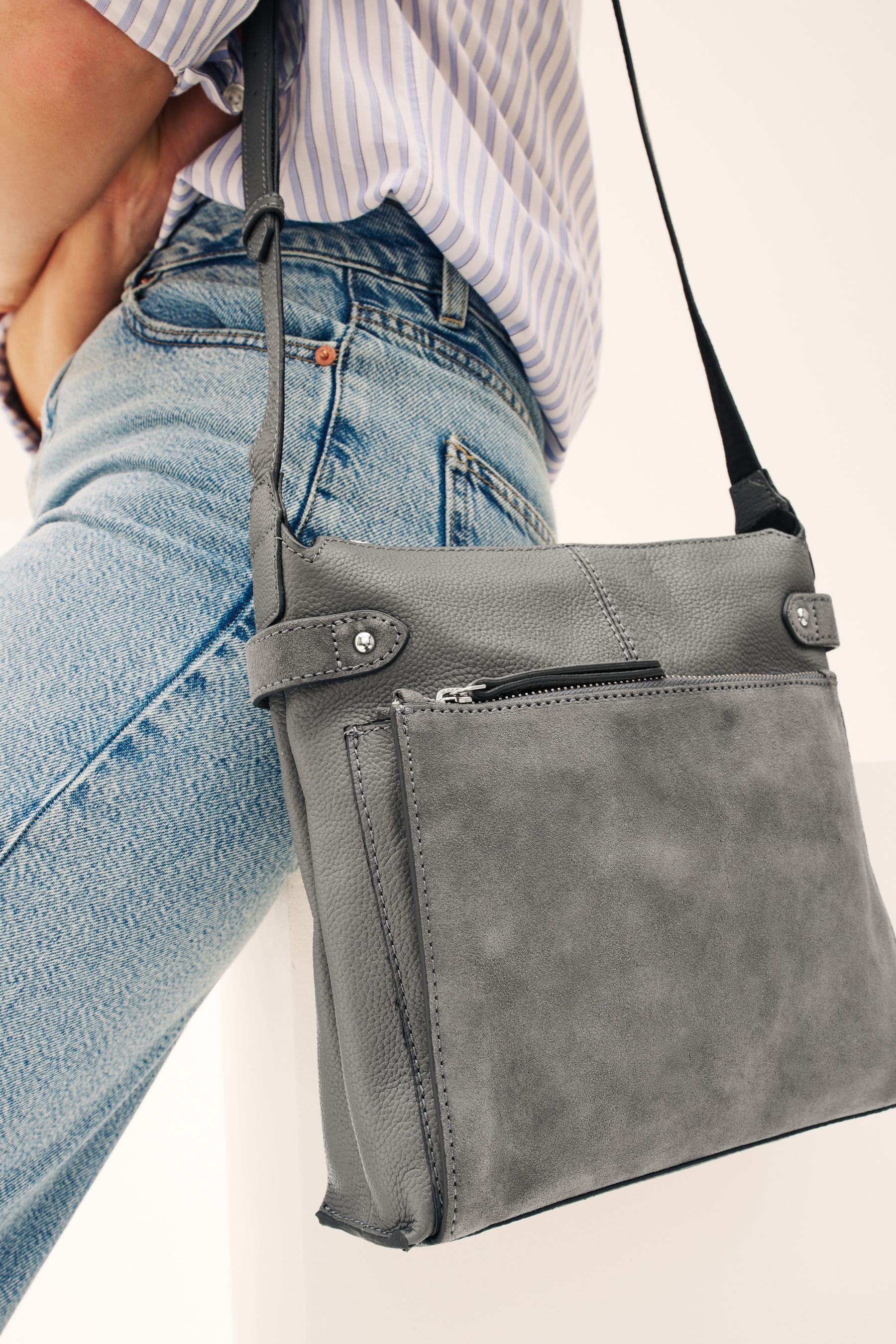 Grey leather messenger bag top