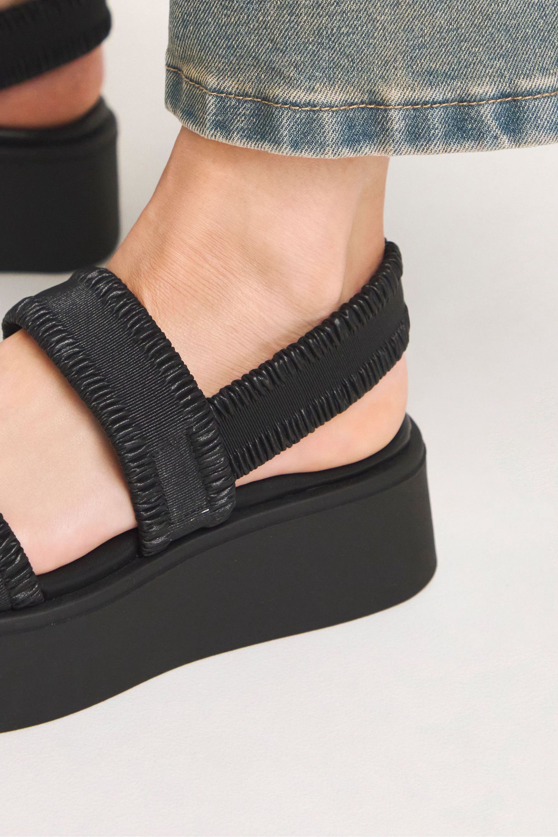 Black strappy flatforms 2025