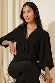 Friends Like These Solid Black Petite V Neck Bow Front 3/4 Sleeve Blouse - Image 1 of 4