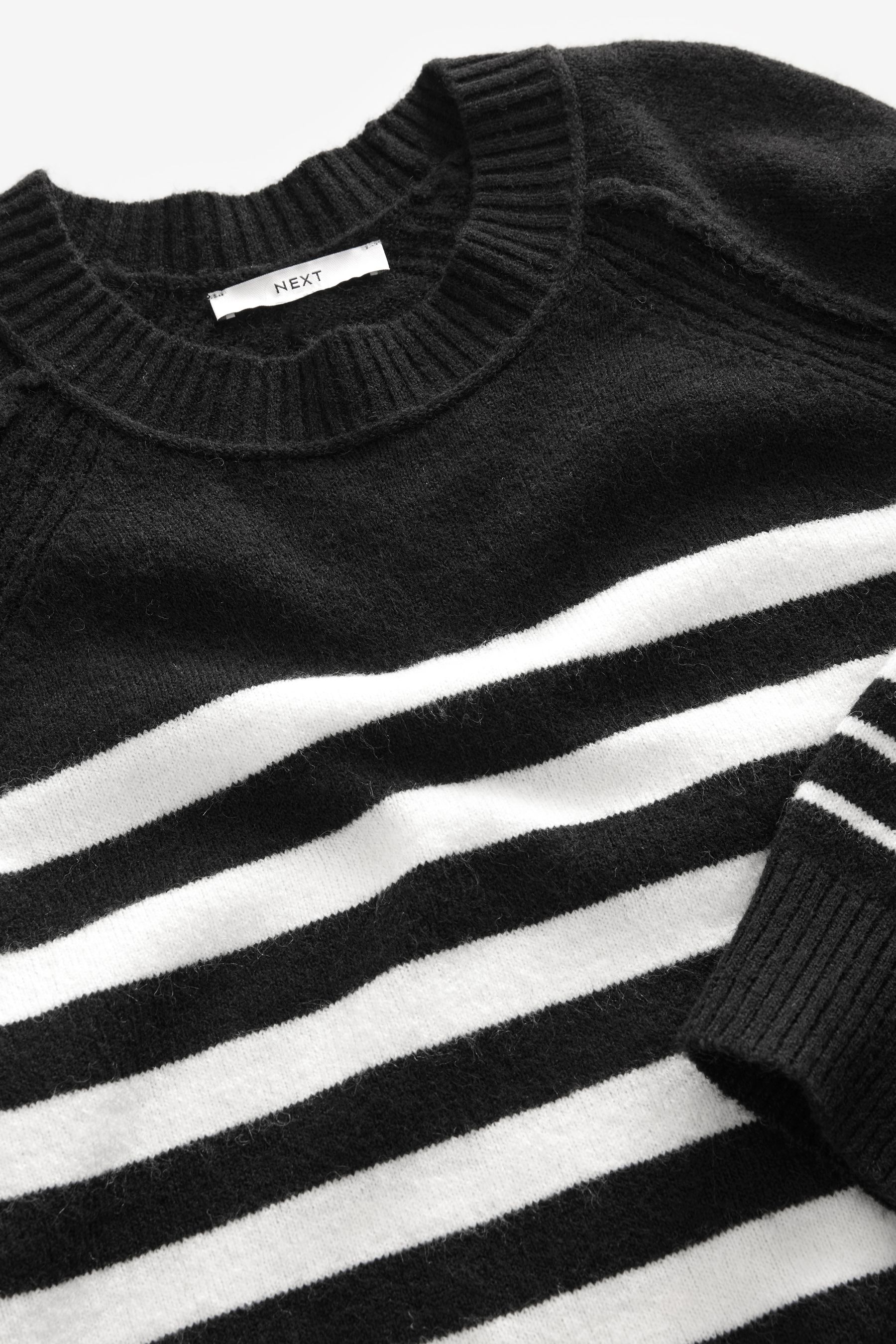 Black jumper with white stripes on sleeve discount