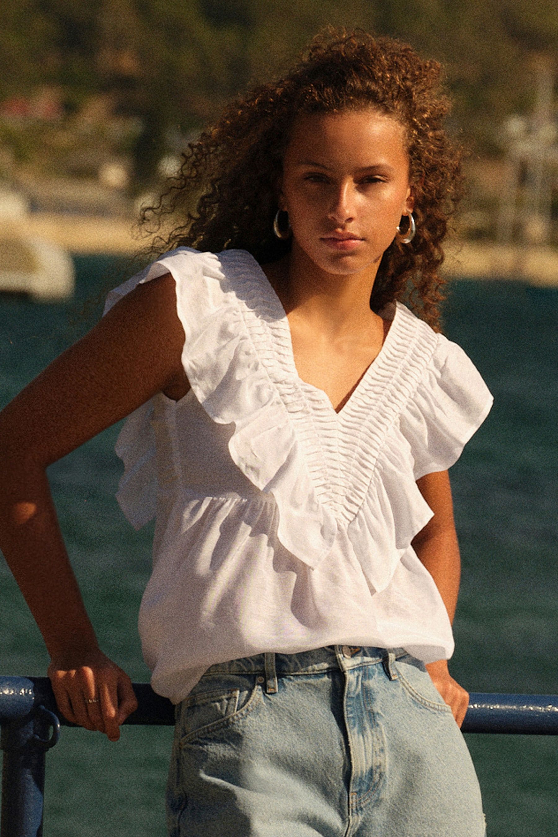 White sleeveless ruffle top sales