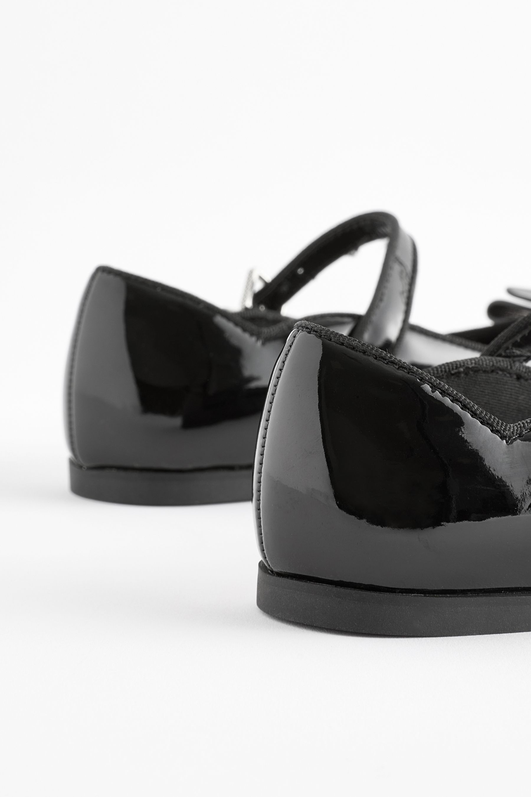 Girls black ted baker shoes top