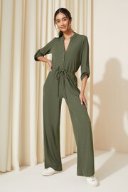 Friends Like These Khaki Green Petite Jersey Long Sleeve Cinched Waist Jumpsuit - Image 1 of 4