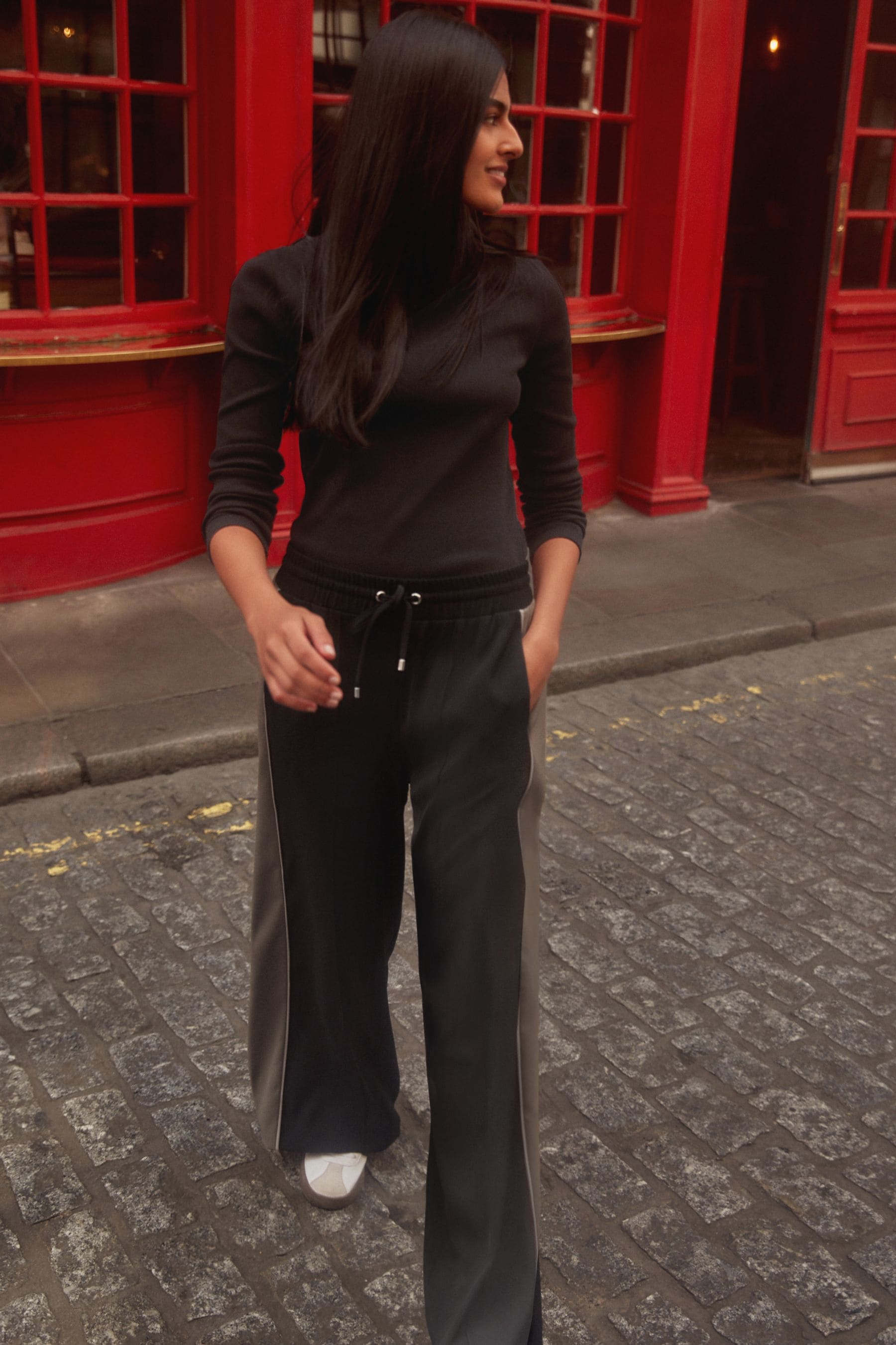 Black pants with red side stripe top