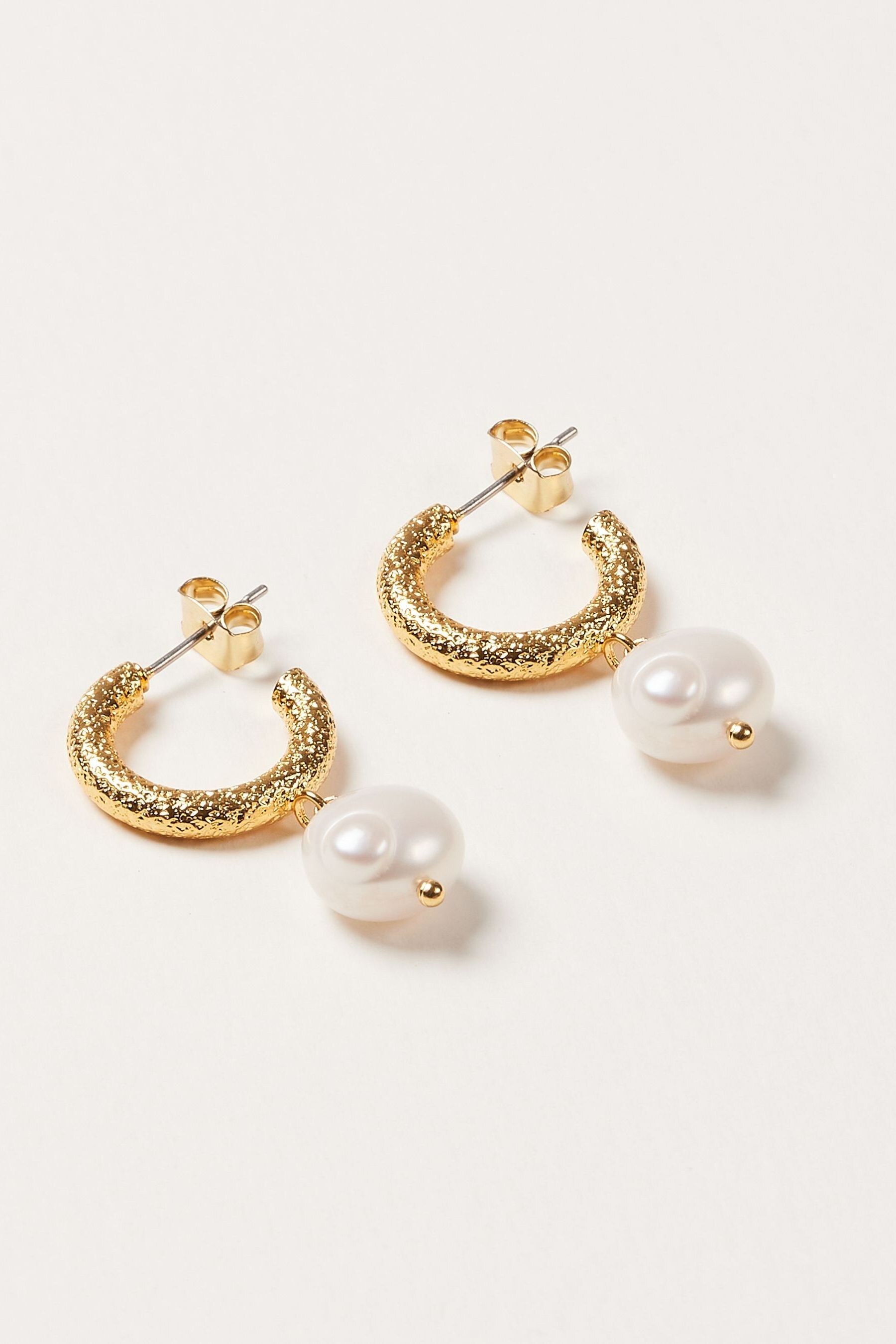 Buy Oliver Bonas Gold Tone Thea Faux Pearl Drop Textured Hoop Earrings from the Next UK online shop