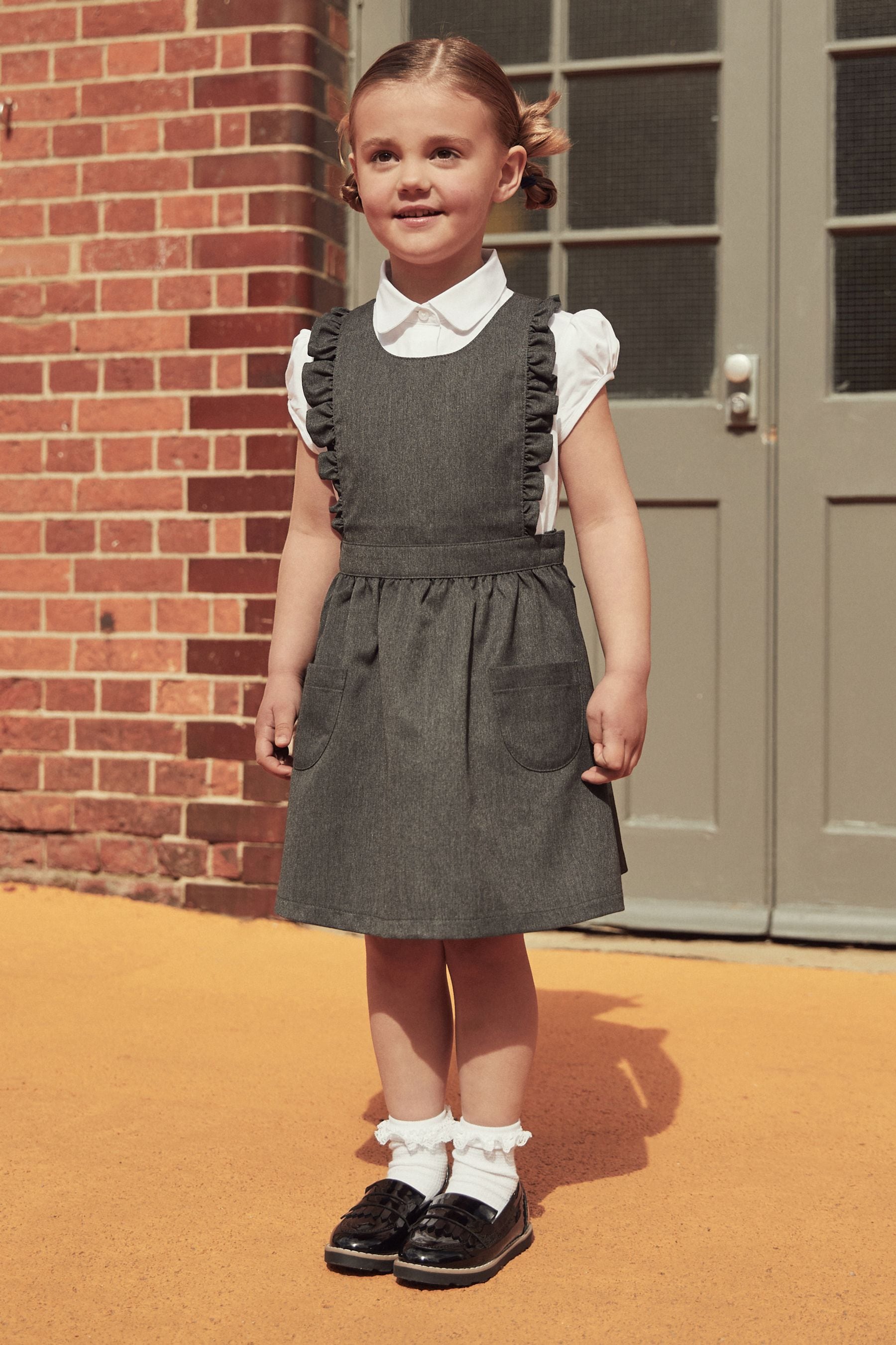Buy Grey Ruffle Detail Pinafore School Dress 3 14yrs from Next Luxembourg