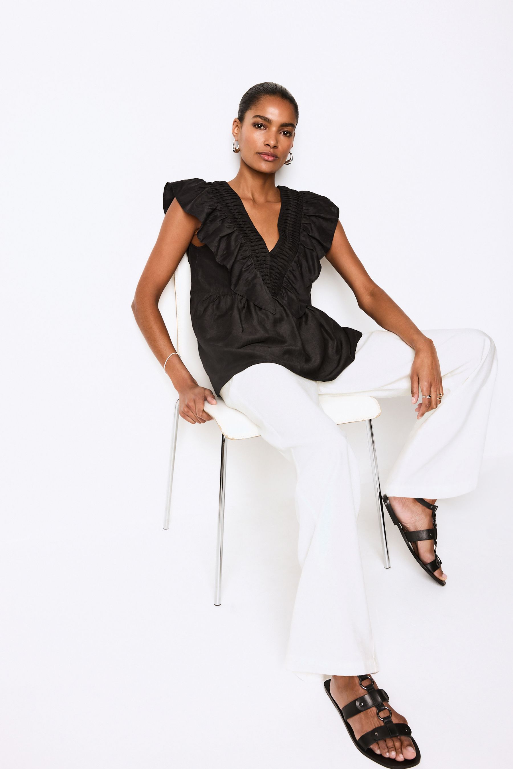 Black sleeveless ruffle top on sale