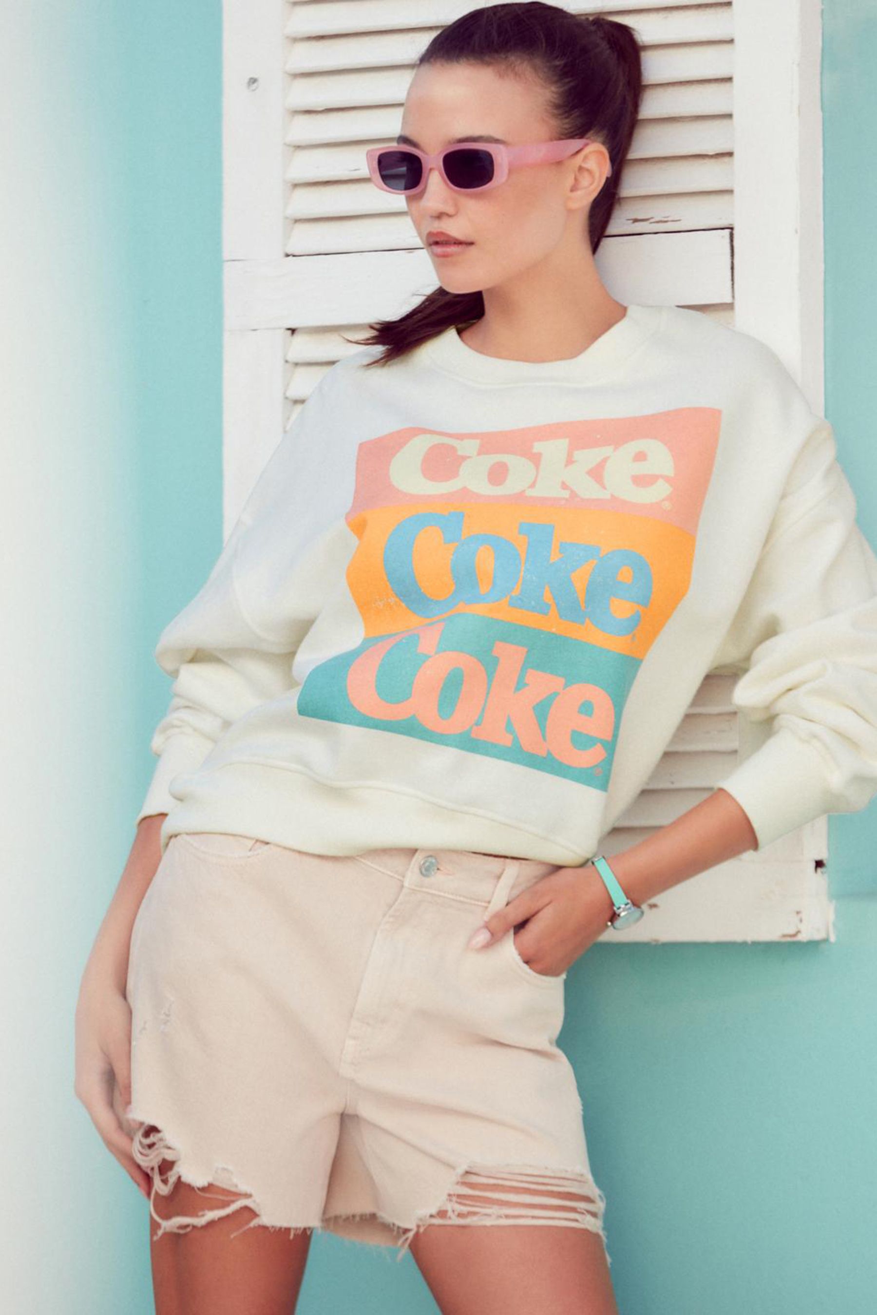 Buy Ecru White License Coca Cola Summer Graphic Relaxed Fit Slogan Sweatshirt from Next Luxembourg