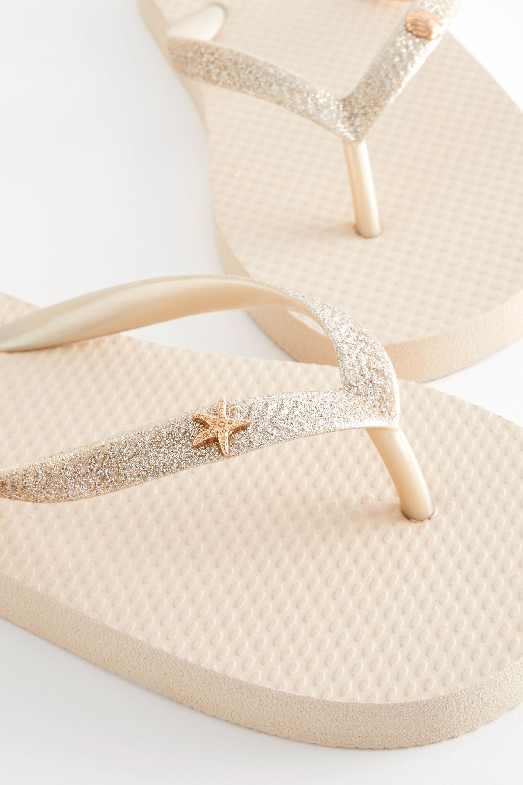 Gold glitter flip flops top