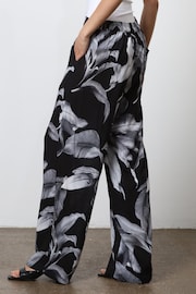 Religion Black Wide Leg Trousers in Botanic Print in Crepe - Image 3 of 7